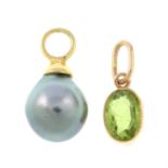A grey cultured pearl pendant and a peridot pendant.