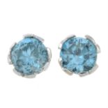 A pair of blue zircon and diamond stud earrings.