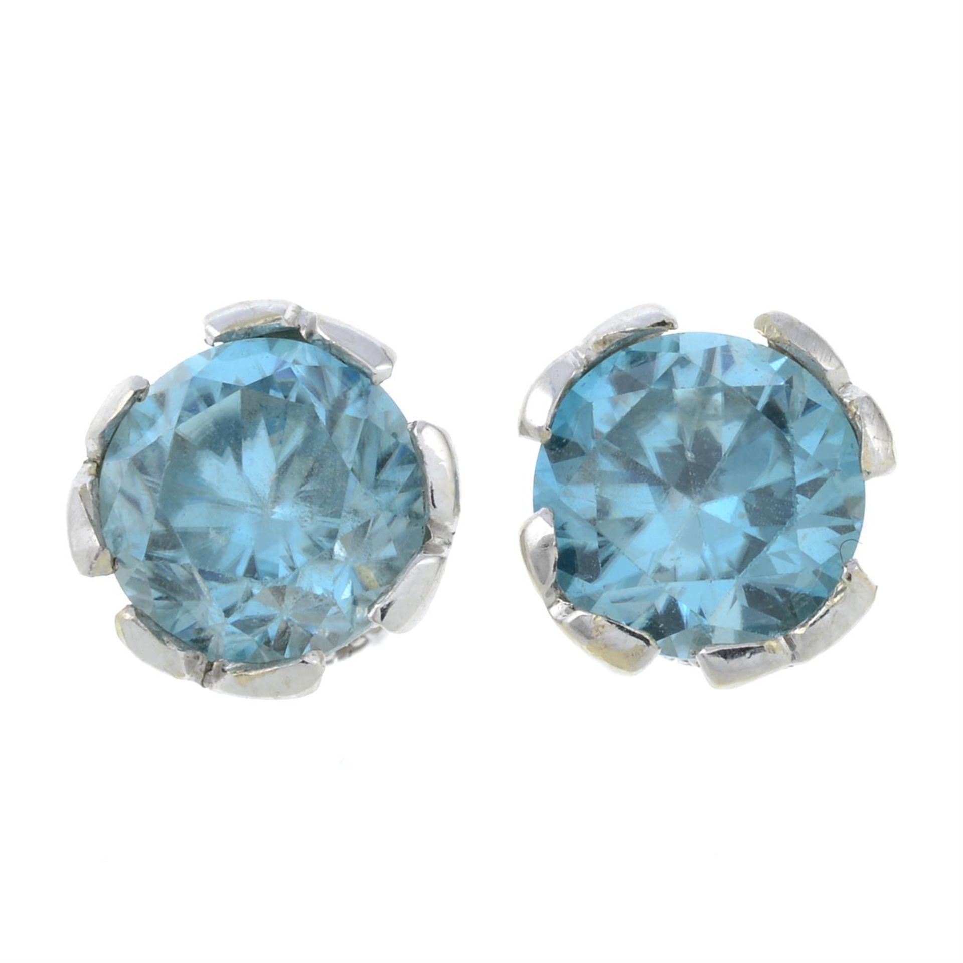 A pair of blue zircon and diamond stud earrings.