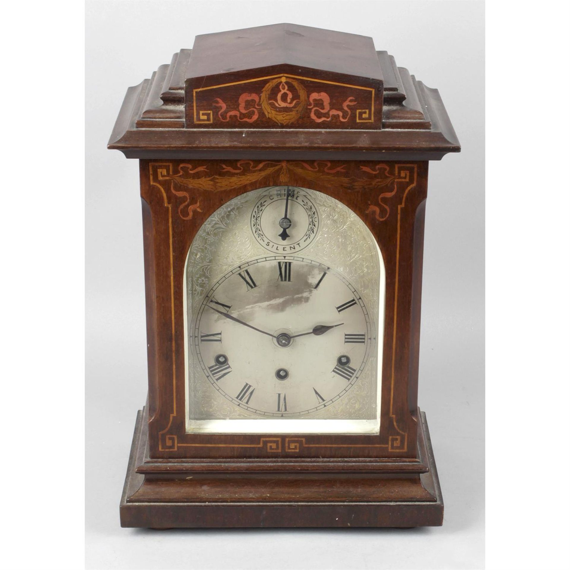 An Edwardian inlaid mahogany cased bracket style mantel clock.