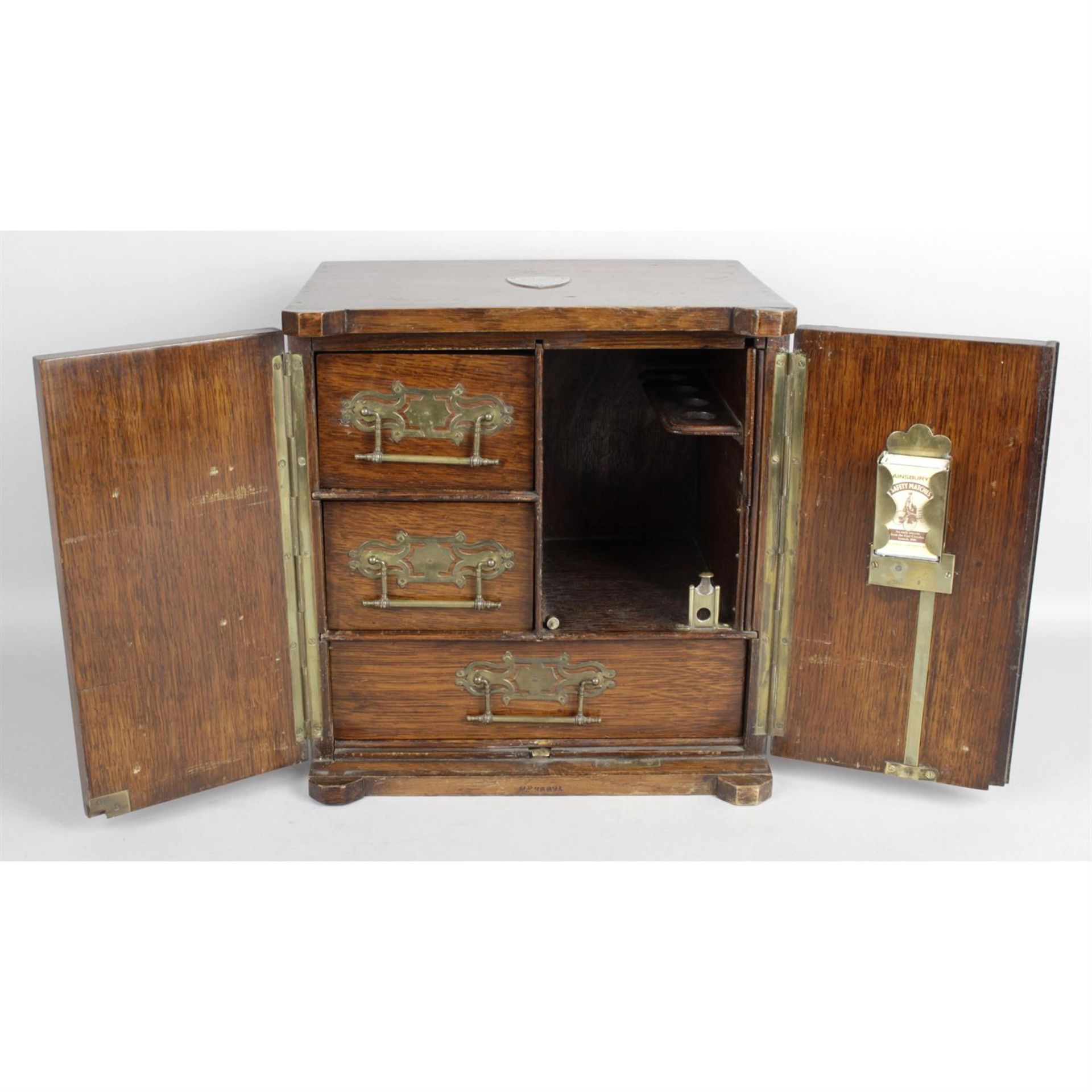 A late 19th century novelty oak smokers cabinet modelled as a twin door safe - Image 2 of 2