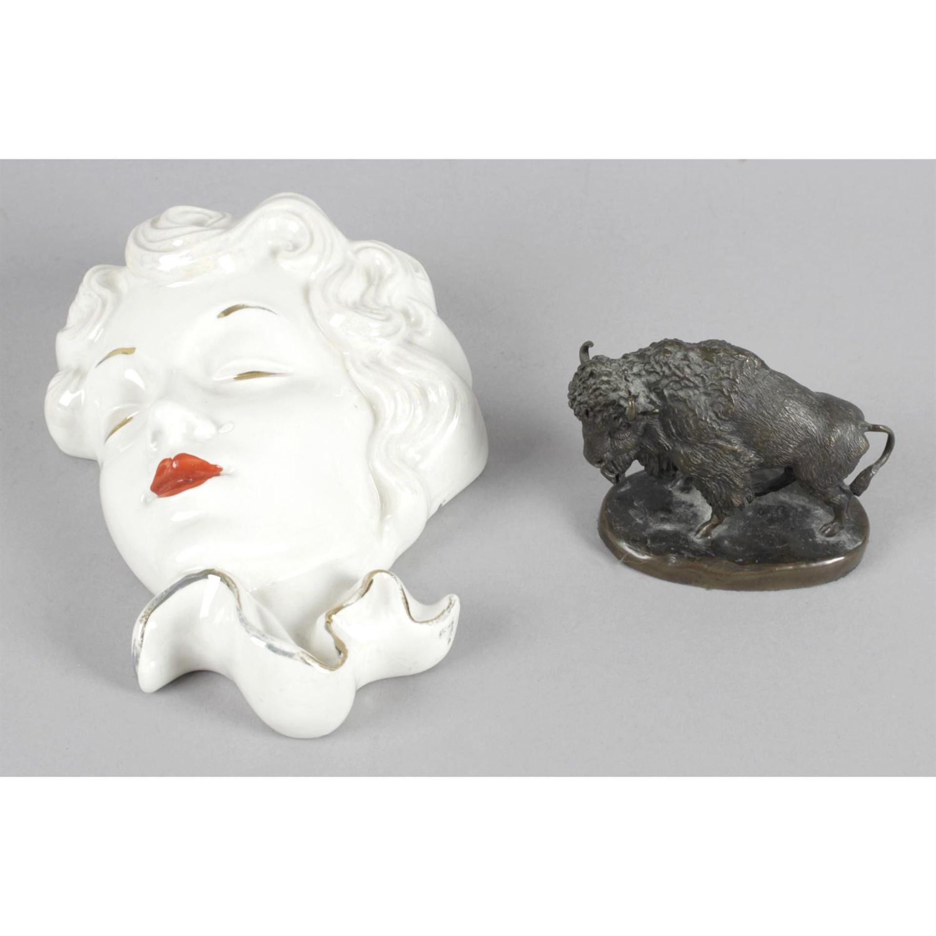 An Empire-style mirror, a modern lamp, a pottery face mask, and a small bronze buffalo. (4).