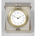 A silver cased folding travel clock.