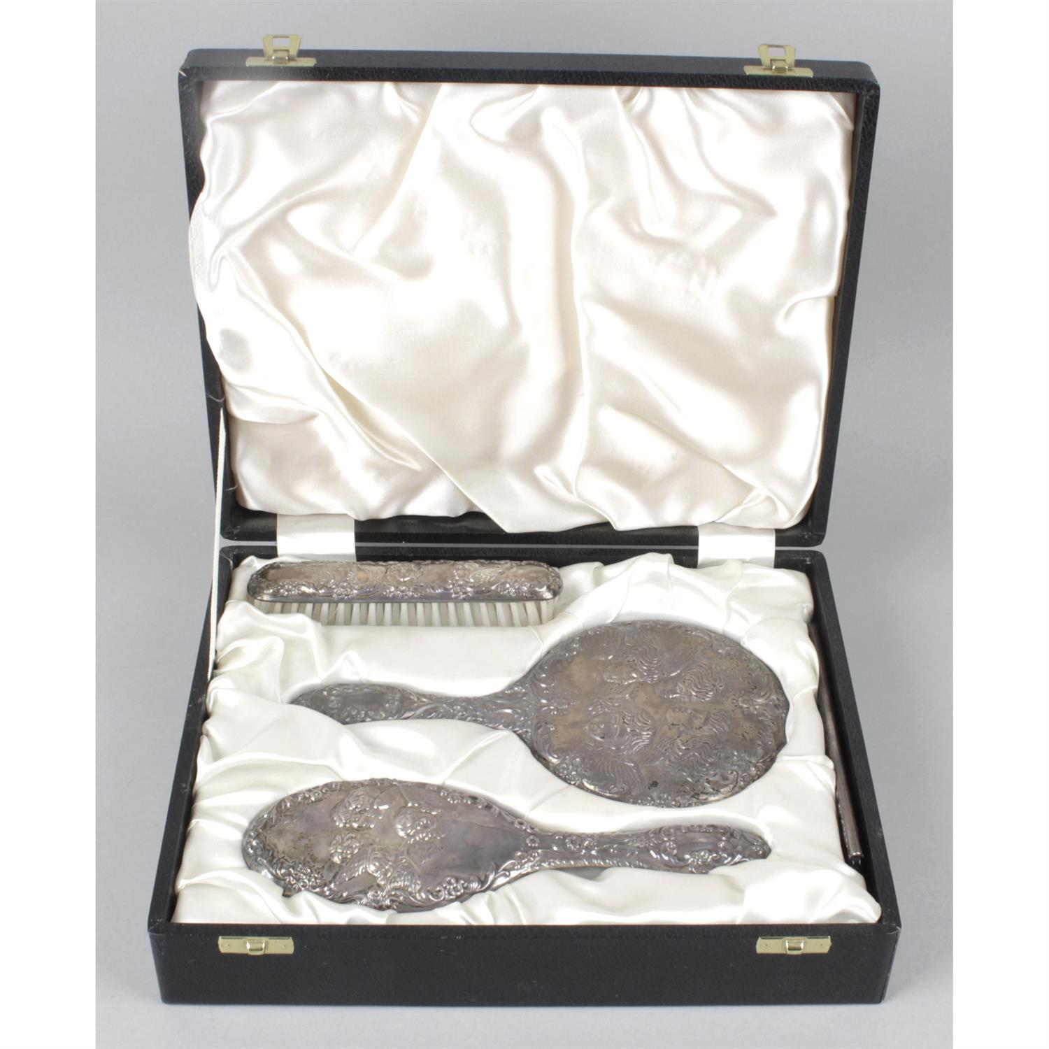 A cased silver mounted dressing table set.