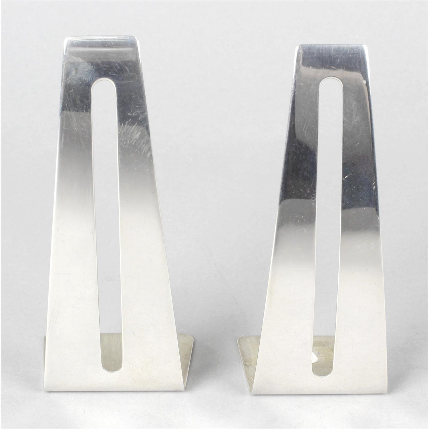 A pair of silver business card stands.