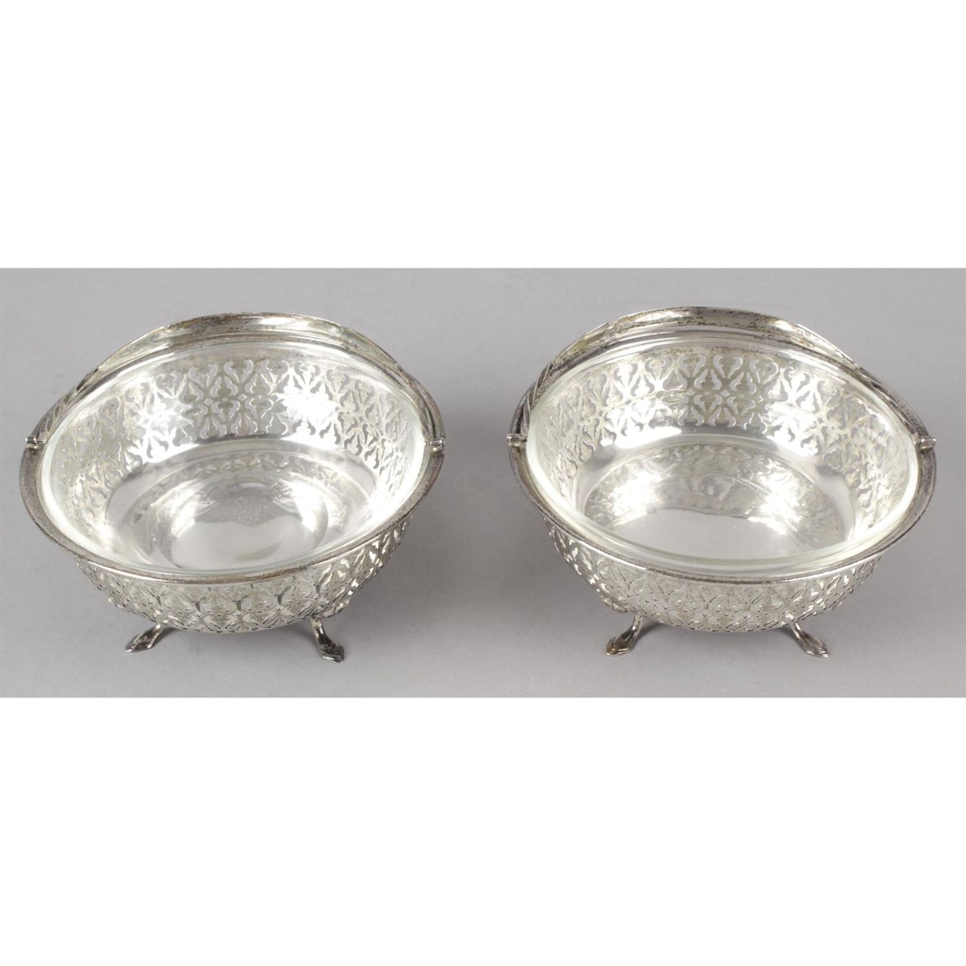 A pair of George V silver pierced swing-handle dishes with glass liners. - Image 2 of 3