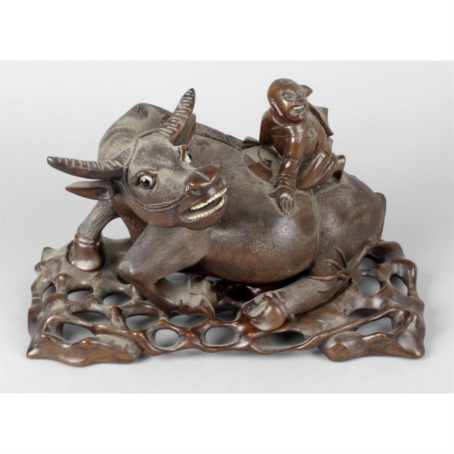 A large early 20th century Chinese carved hardwood study of a water buffalo.