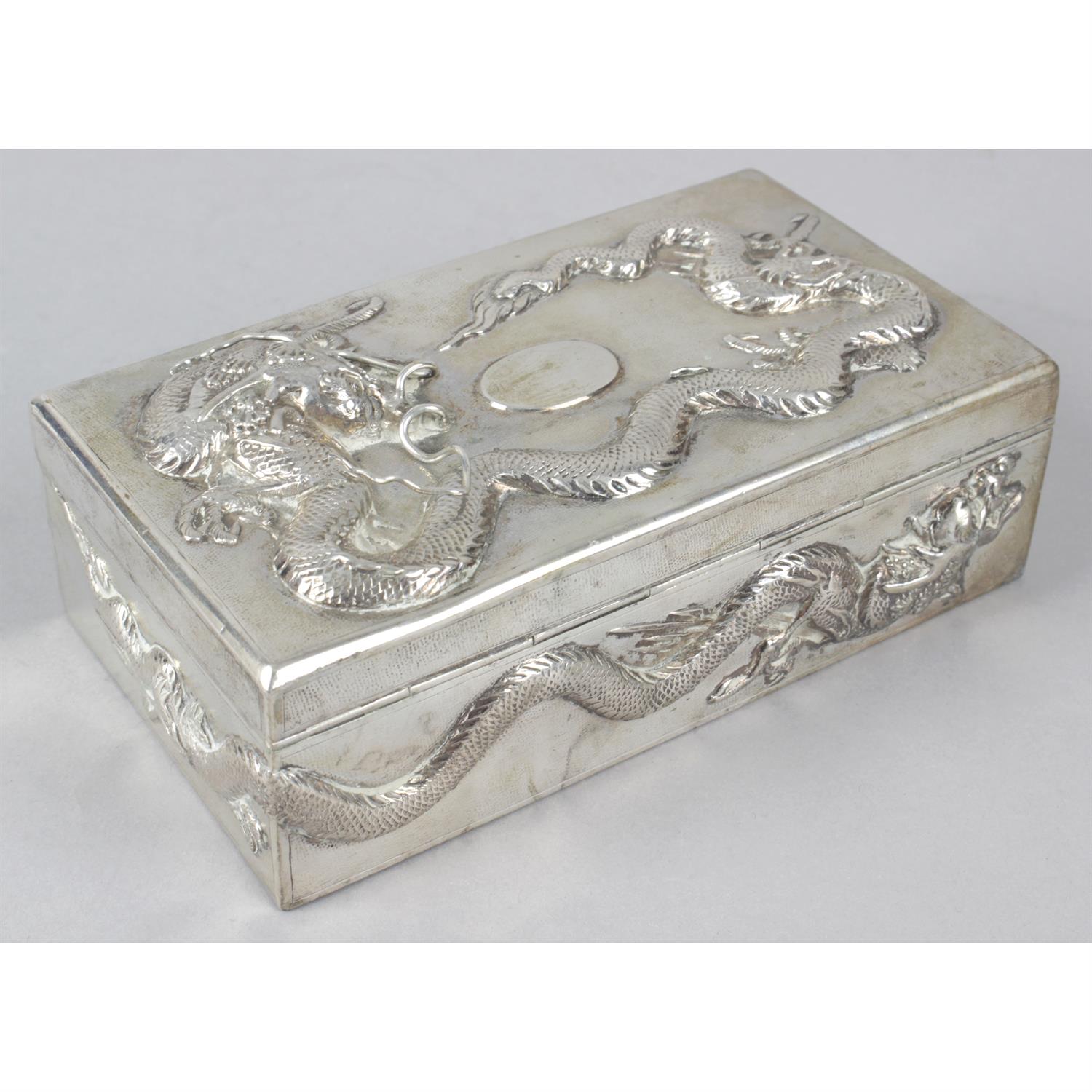 A Chinese export silver table cigarette box decorated with dragons in relief. - Image 2 of 3