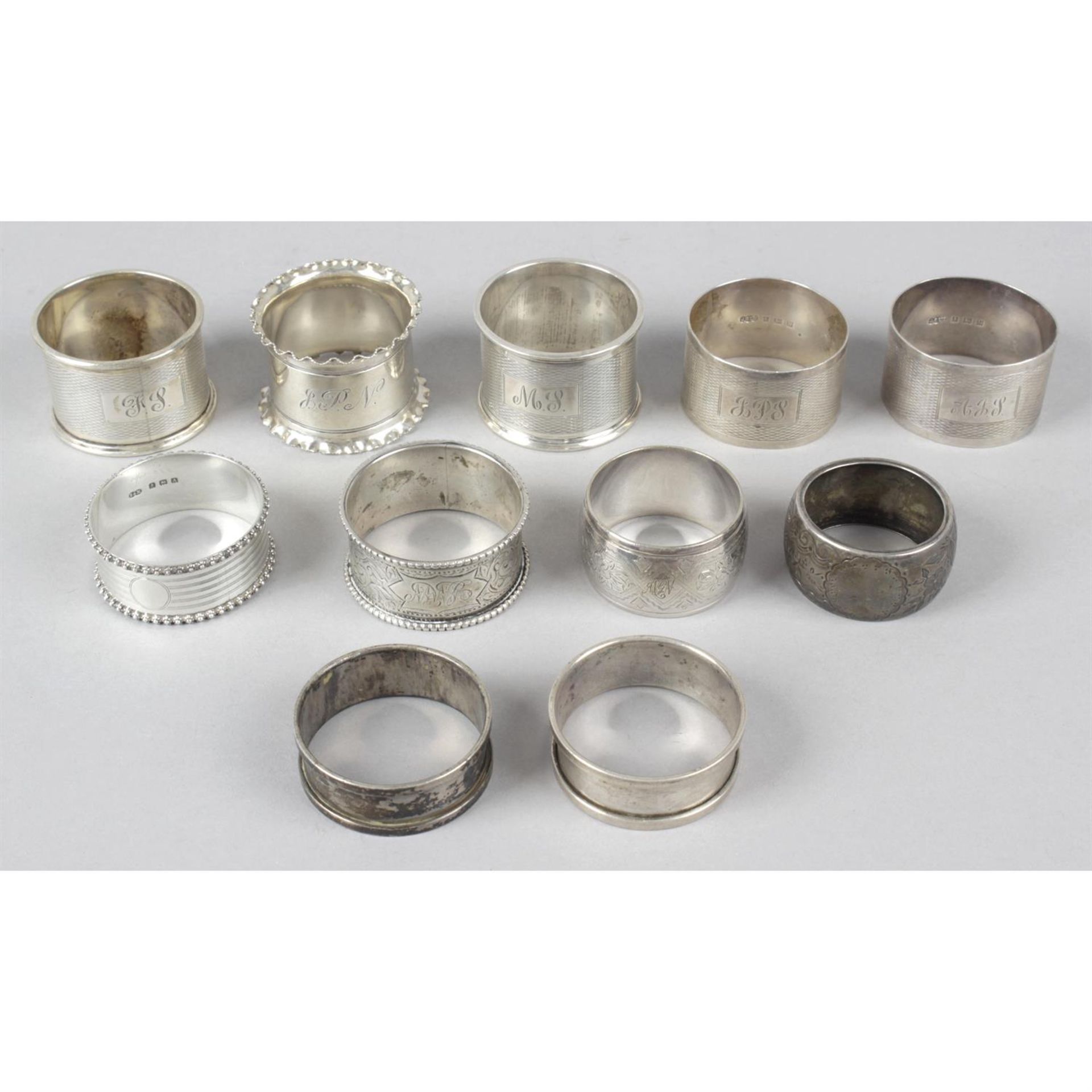 A selection of ten silver napkin rings and a single plated example. (11).