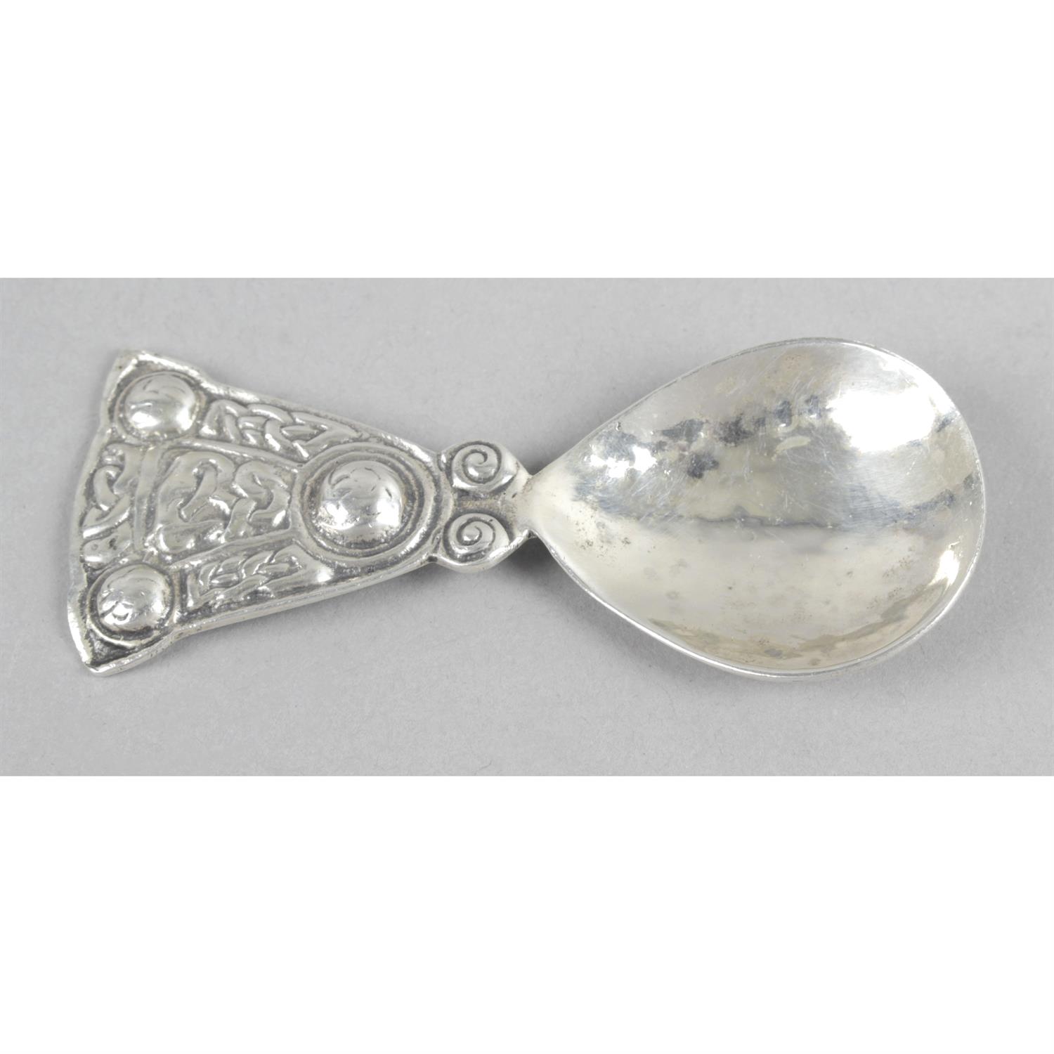 A silver caddy spoon, in the Iona style.