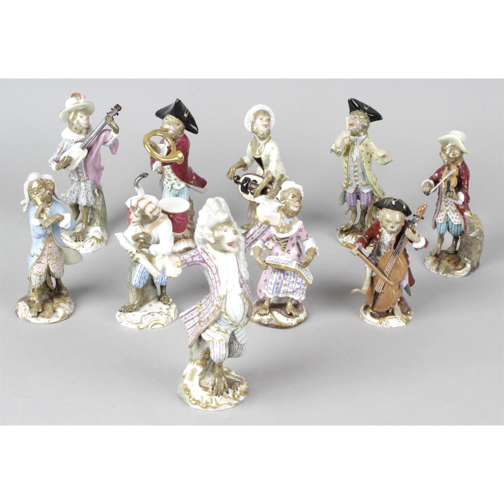 A group of ten porcelain monkey band figurines with Meissen style marks.