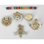 A small mixed selection of military buttons and cap badges.