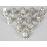 A collection of twelve silver sewing thimbles.
