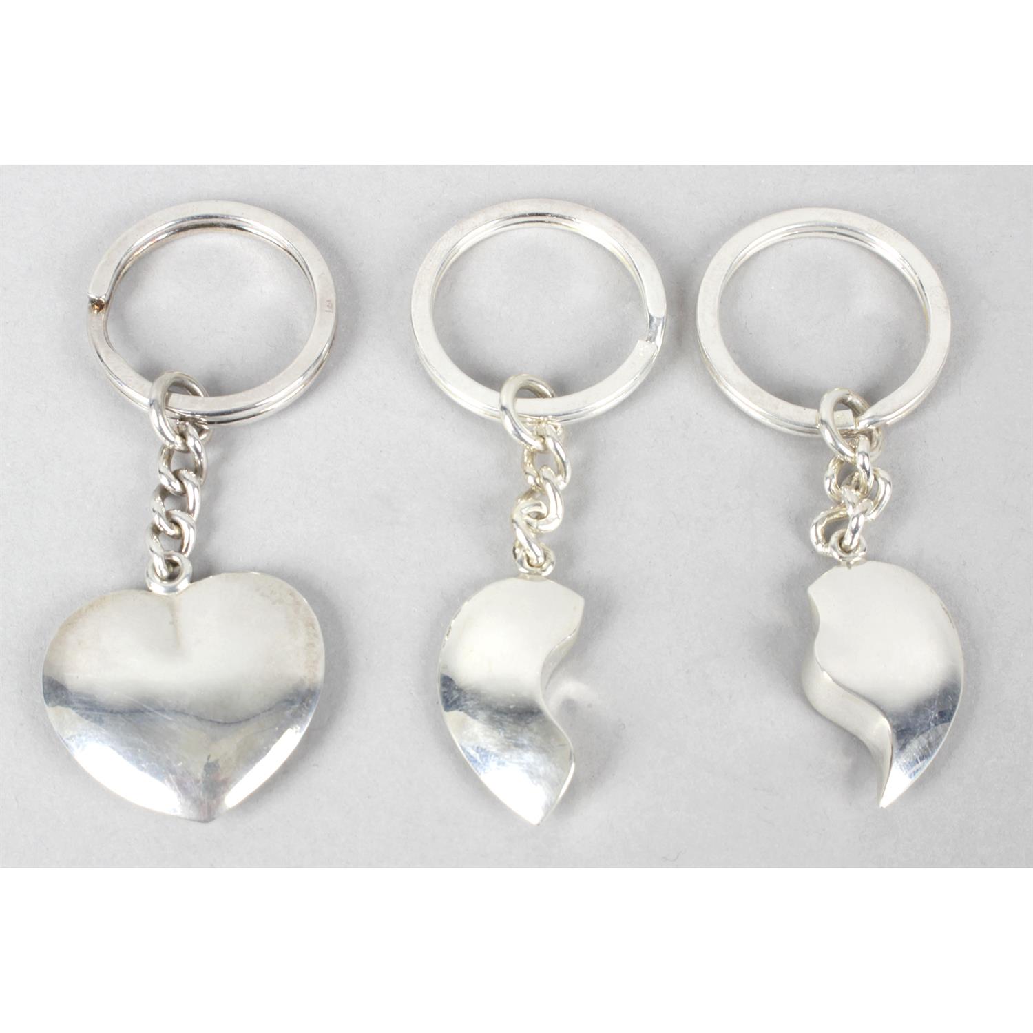 Three silver key rings modelled as hearts.