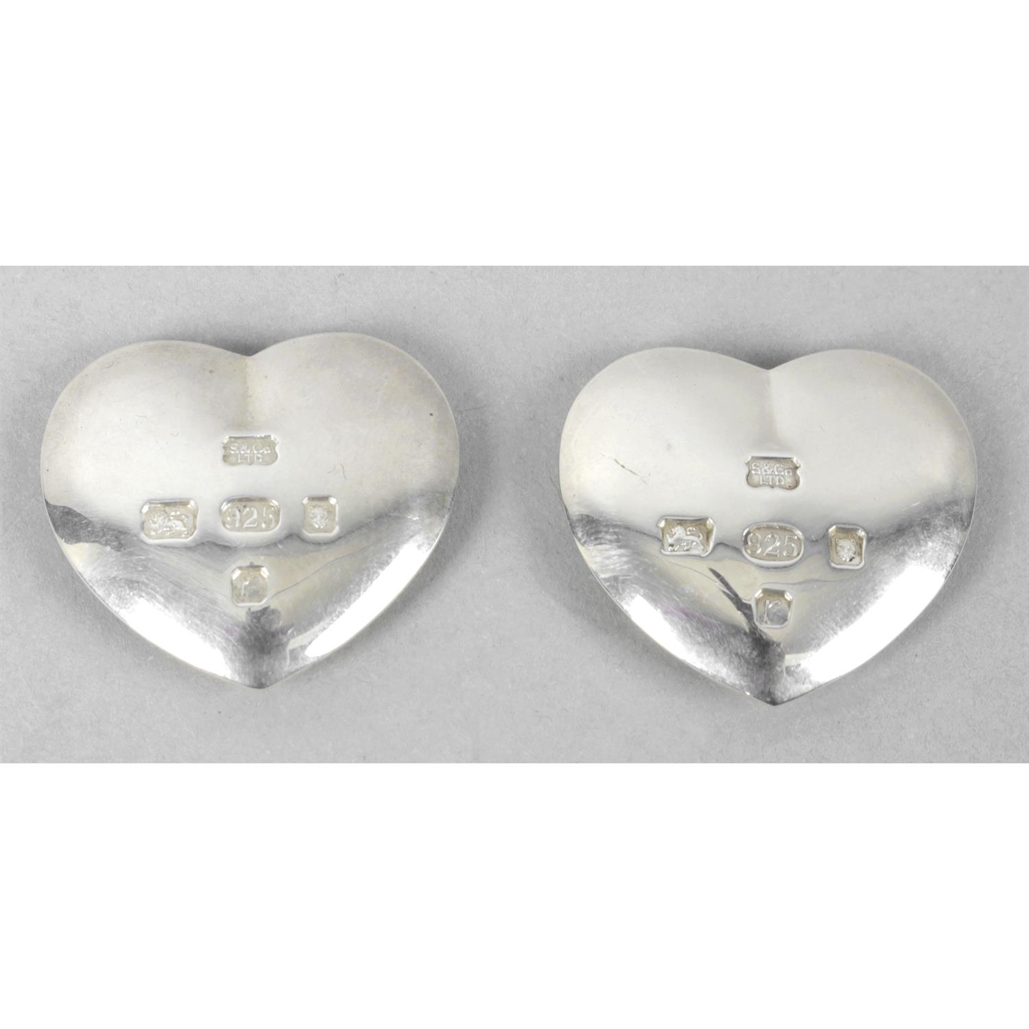 Two small silver hearts.