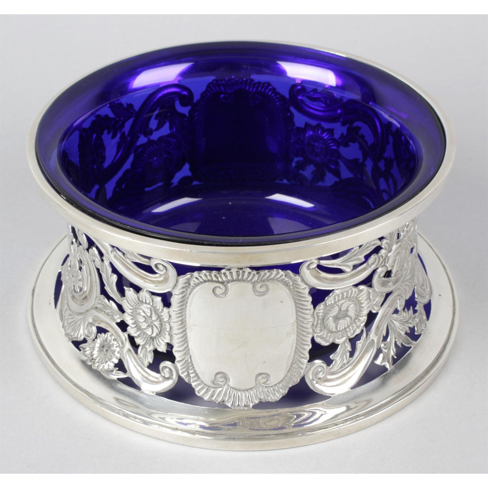 A George V silver dish ring with blue glass liner.