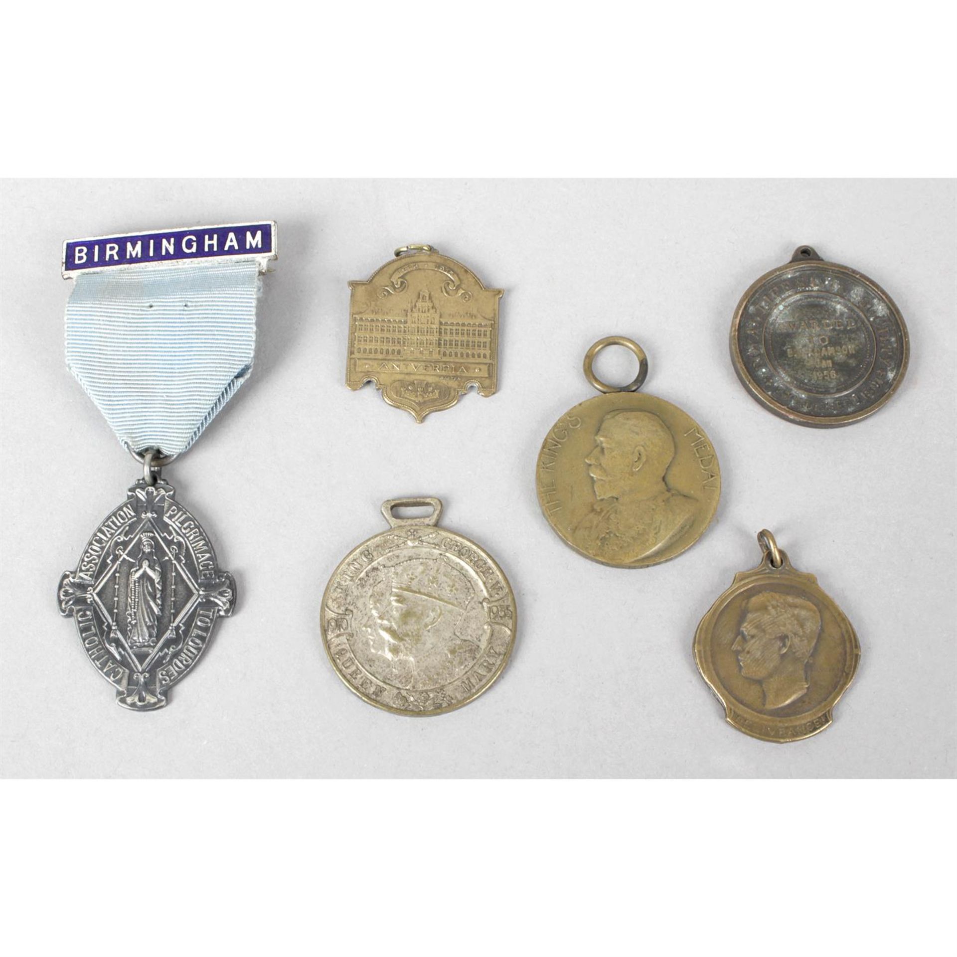 A small mixed selection of base metal badges and bronze medals.