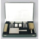A cased 1930's silver mounted dressing table set in Art Deco style.
