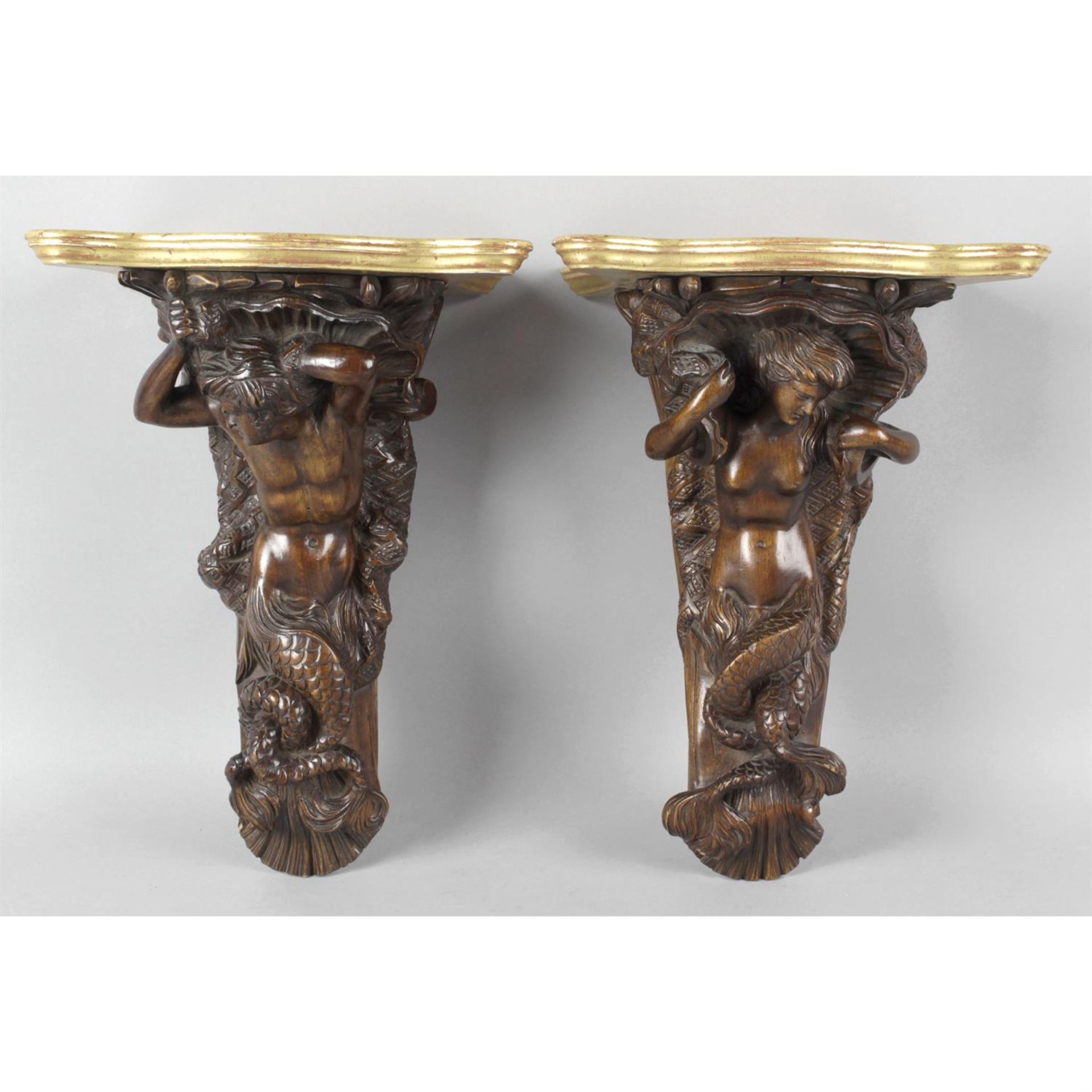 A pair of 19th century carved wooden corbels modelled as a mermaid and merman.