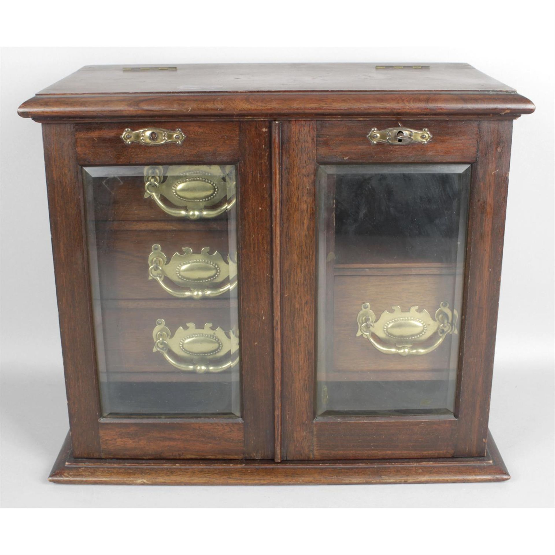 An early 20th century stained mahogany smokers cabinet.