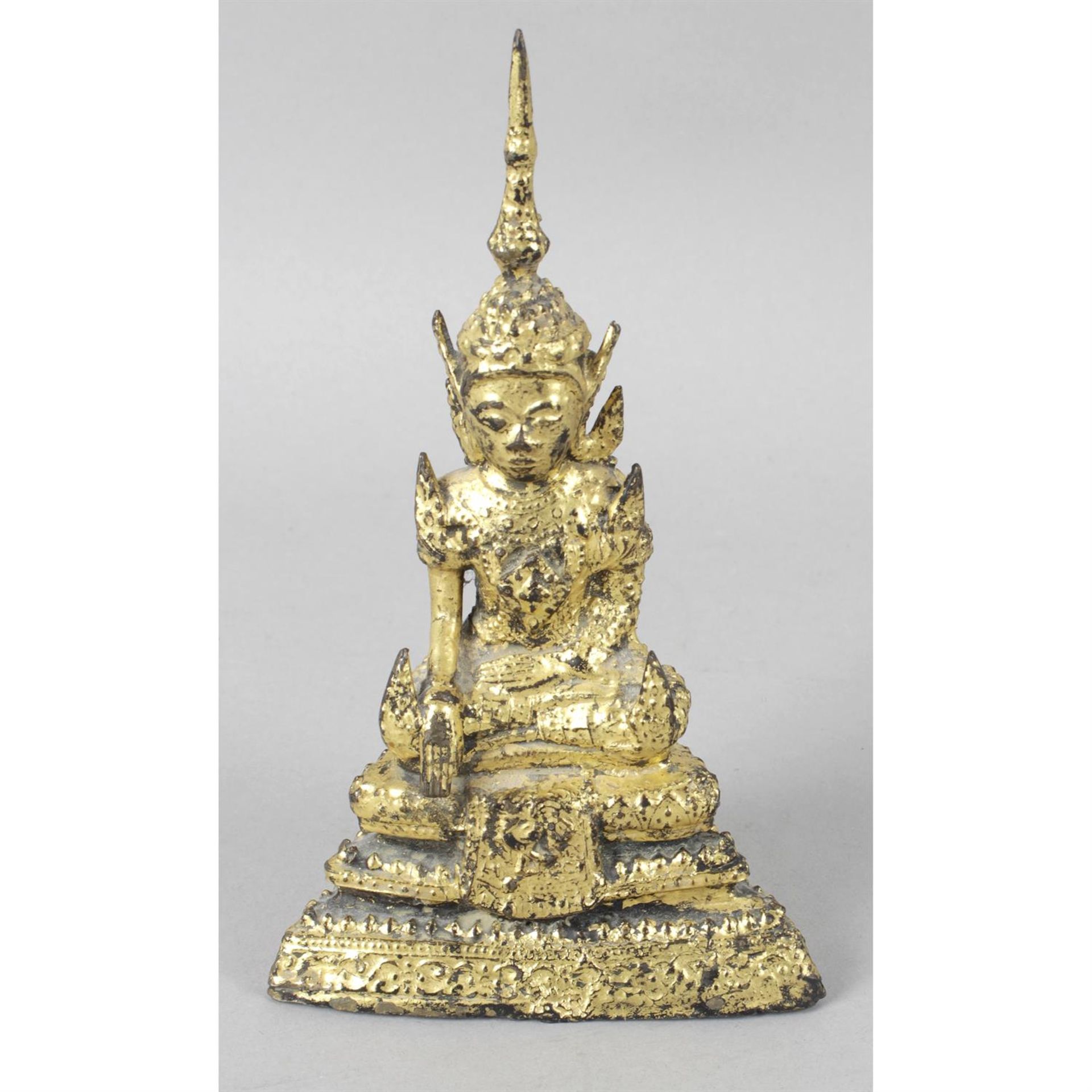 A cast gilt metal figure modelled as an Eastern Buddha.