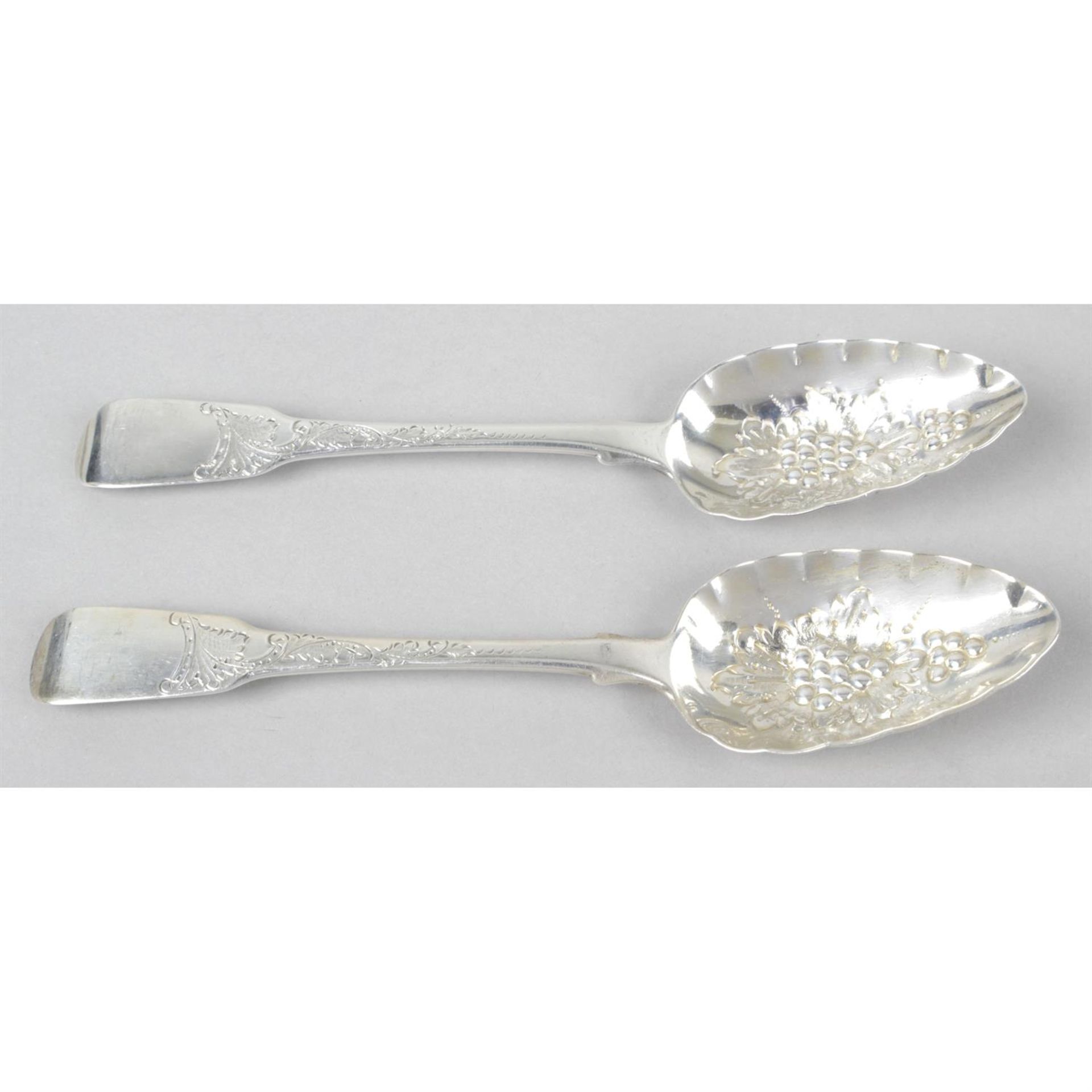 A pair of late George III silver 'berry' table spoons in Fiddle pattern.