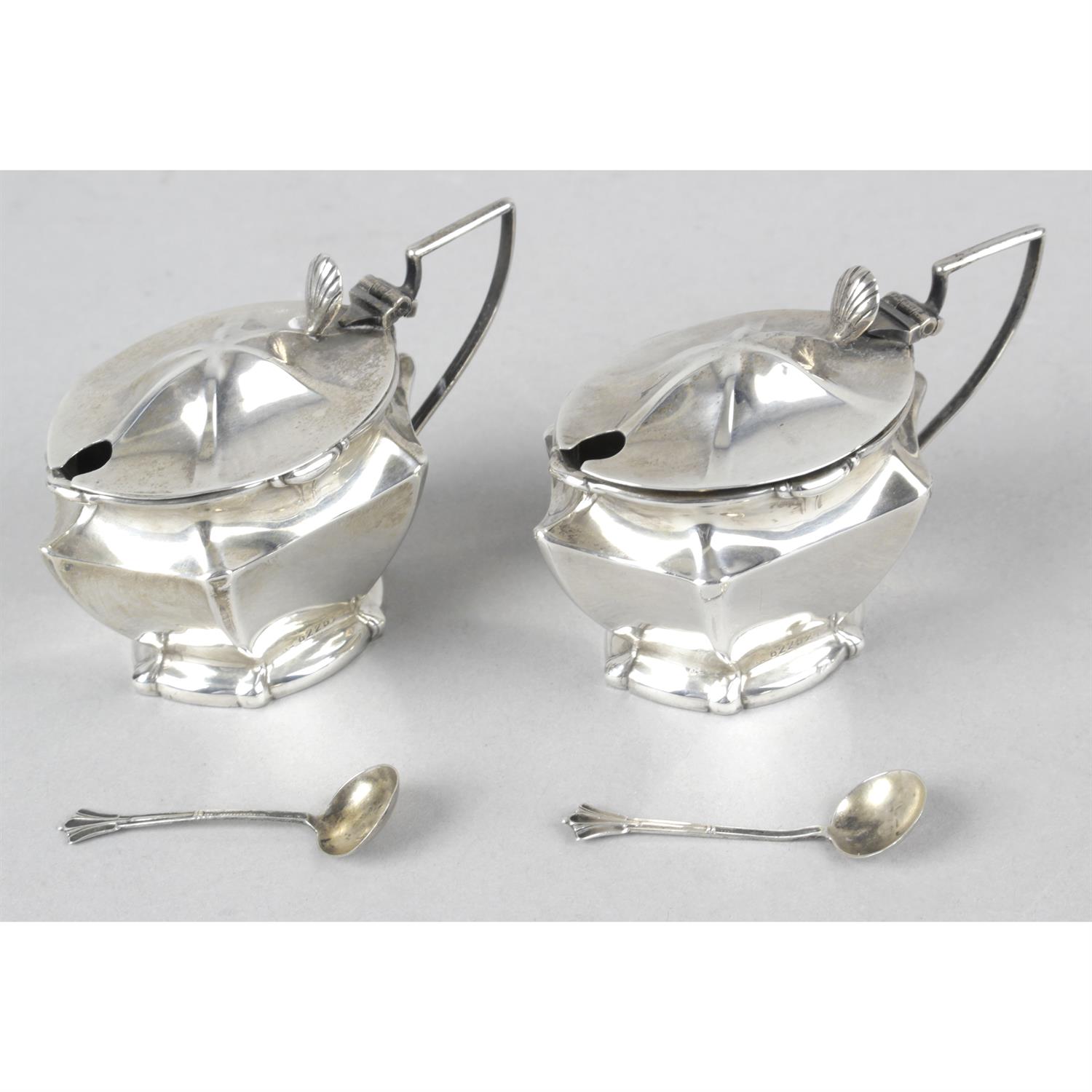 Two silver mustard pots (missing liners), a sugar bowl and cream jug (a.f) and two Italian beakers;