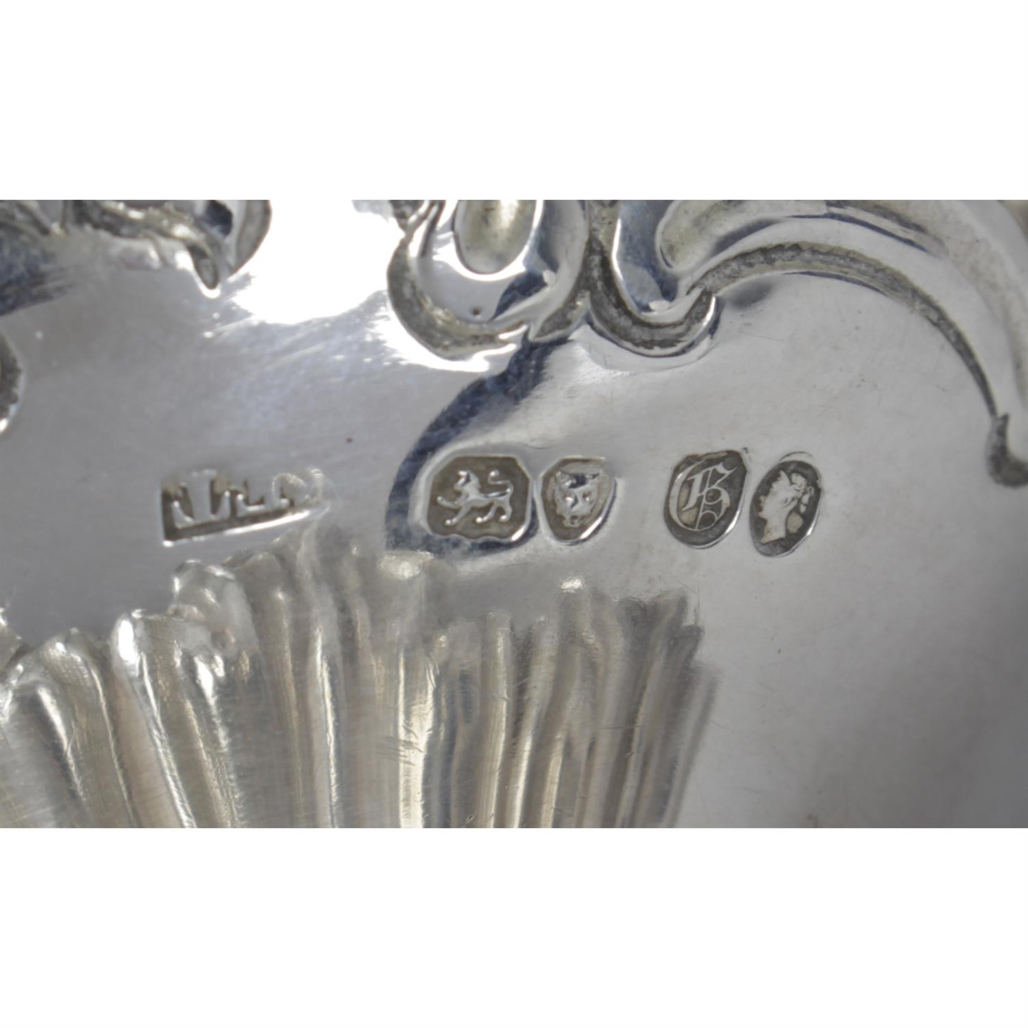 An early Victorian silver pierced and swing-handled sugar basket with blue glass liner. - Image 3 of 3