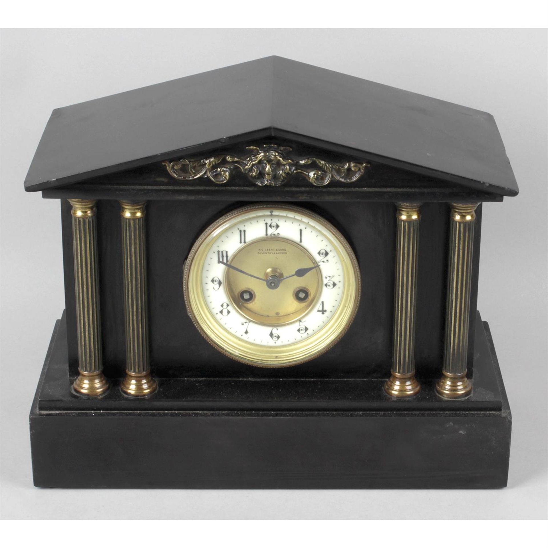 A Victorian black slate mantel clock.