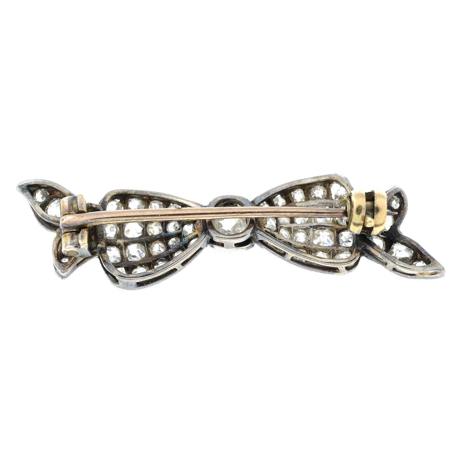 An early 20th century platinum and gold, old-cut diamond bow brooch. - Image 3 of 4