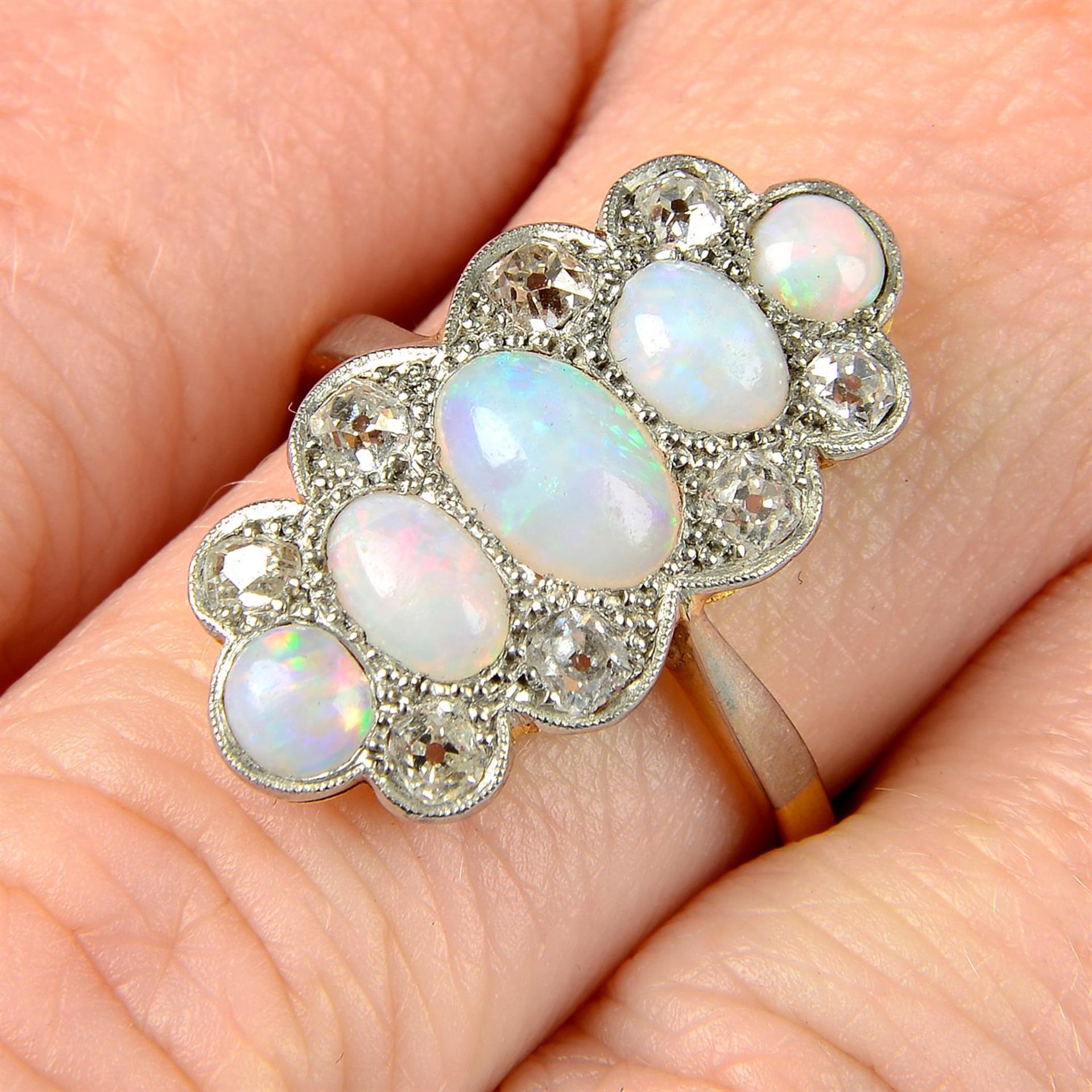 An early 20th century platinum and 18ct gold, opal and diamond ring.