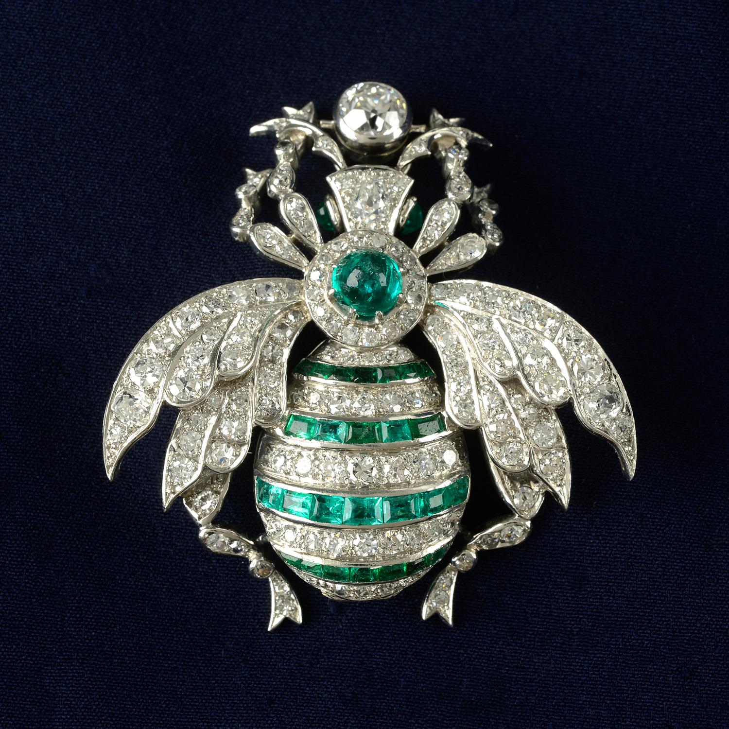 An emerald and diamond bee brooch.