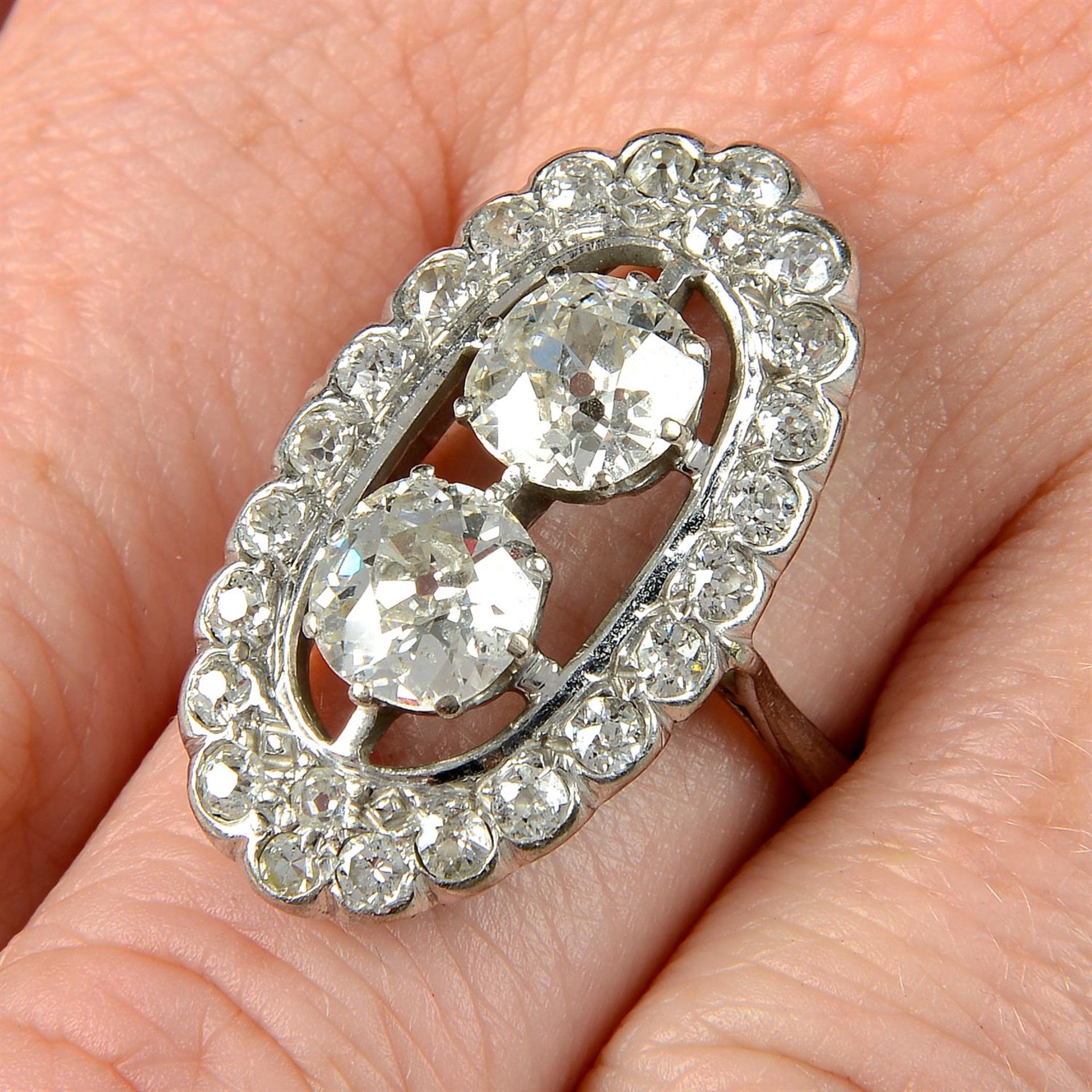 A mid 20th century old-cut diamond two-stone ring, with old-cut diamond shared surround.