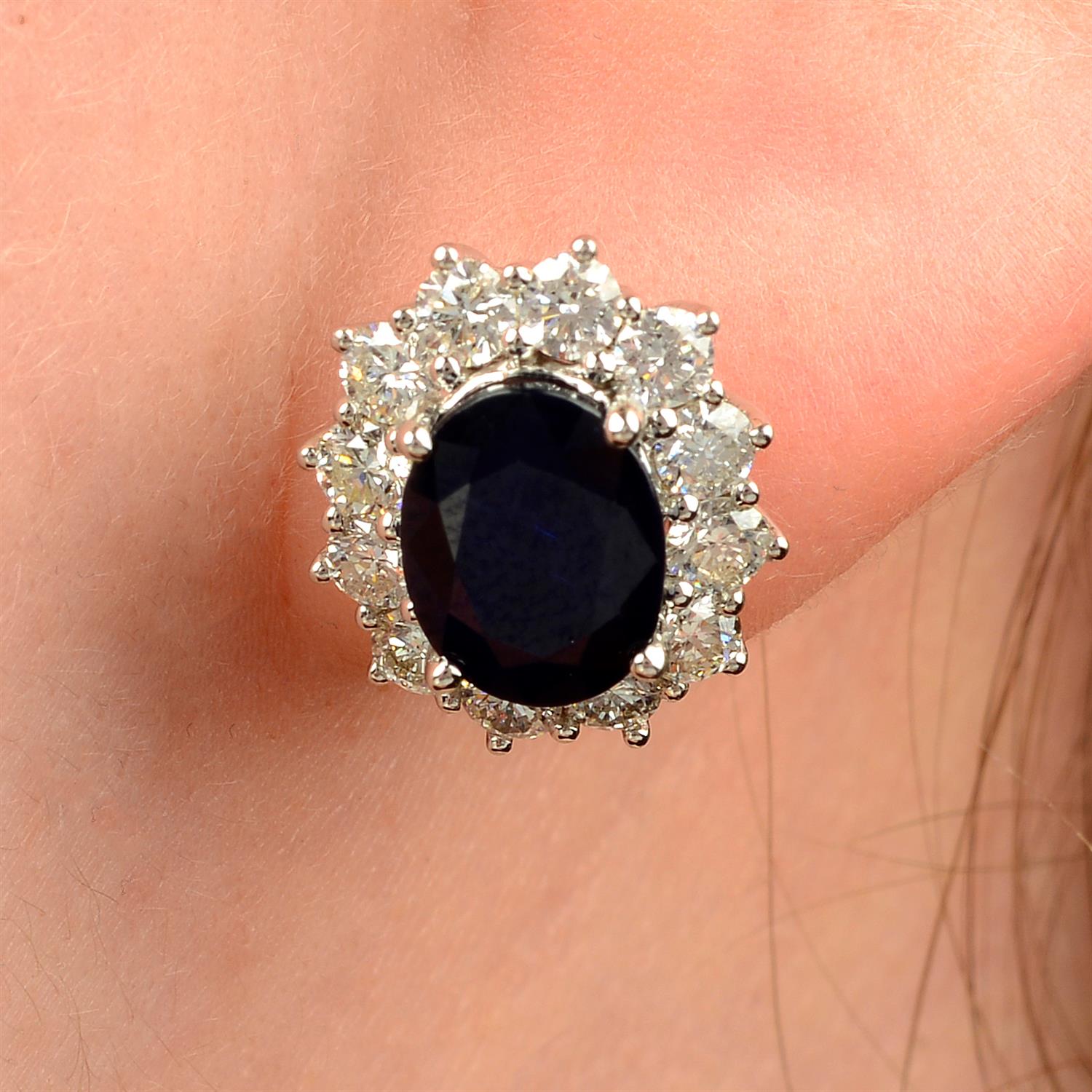 A pair of 18ct gold sapphire and brilliant-cut diamond cluster earrings.