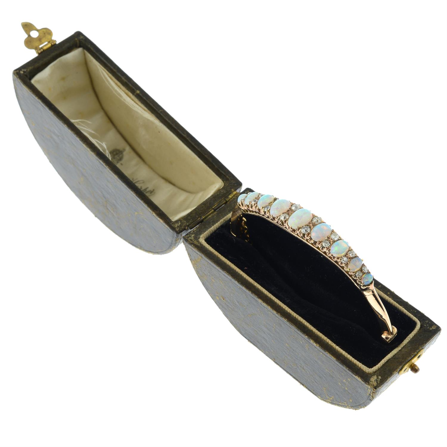 A late Victorian 9ct gold graduated opal hinged bangle, with old-cut diamond spacers. - Image 6 of 7