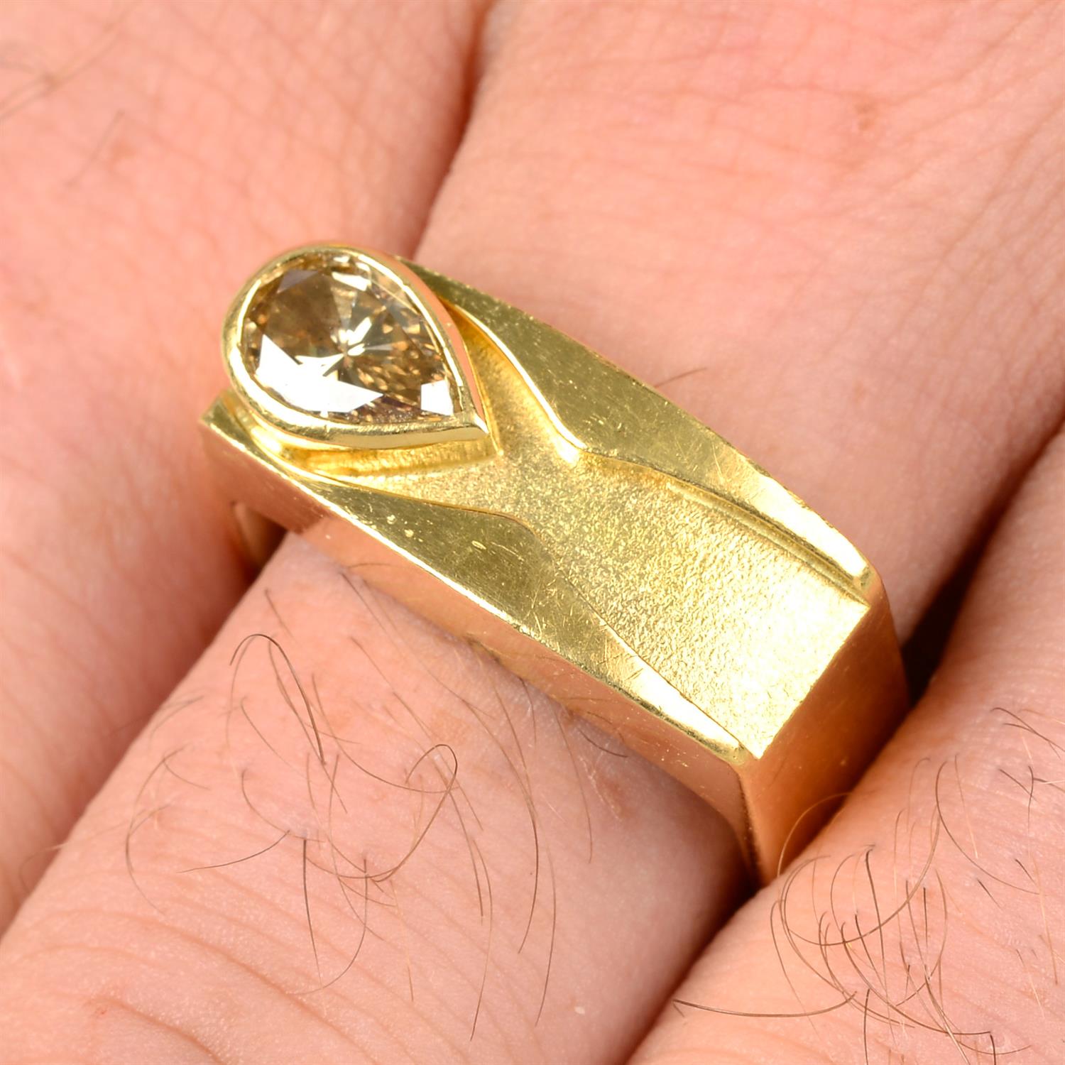 A pear-shape 'light brown' diamond signet ring, by Erwin Springbrunn.