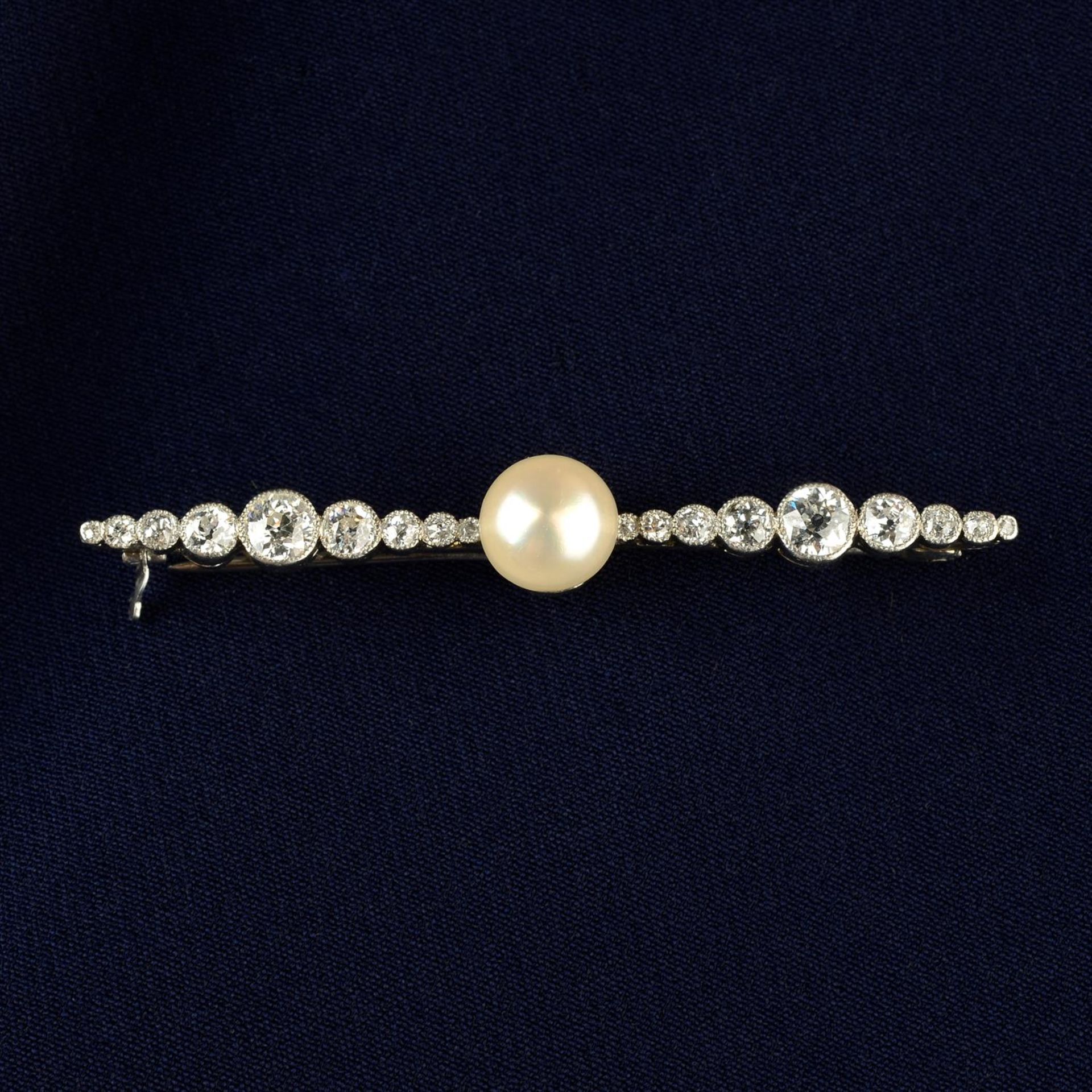 An Art Deco platinum, pearl and graduated circular-cut diamond bar brooch.