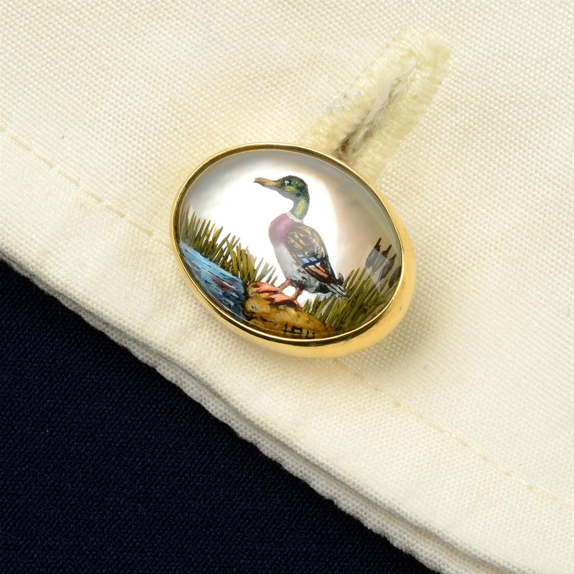 A pair of 18ct gold reverse-carved and painted rock crystal cufflinks, depicting a mallard duck and