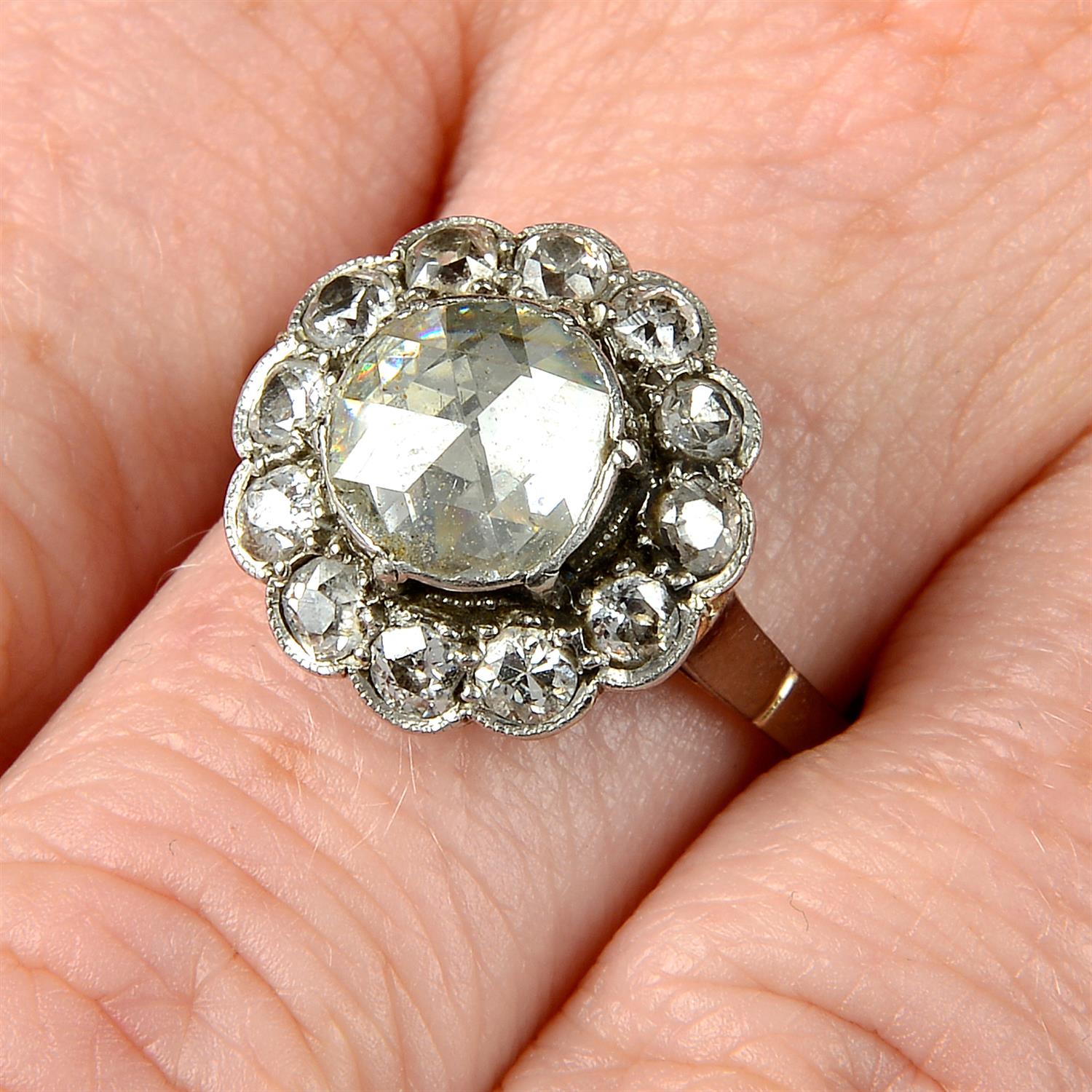 A rose and circular-cut diamond cluster ring.