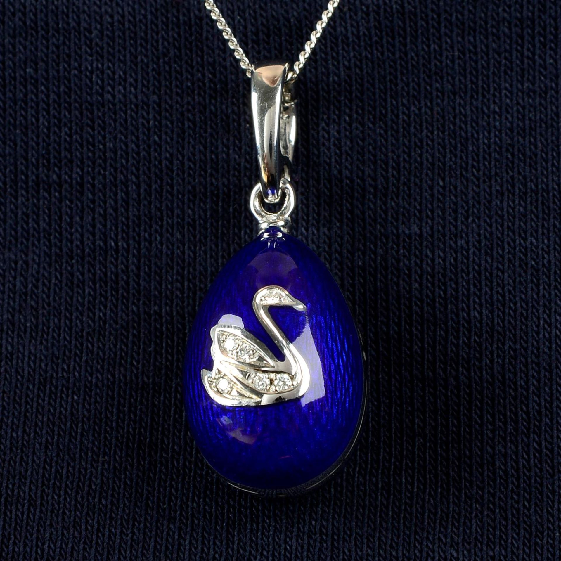 A limited edition 18ct gold diamond and blue enamel egg pendant, by Fabergé.