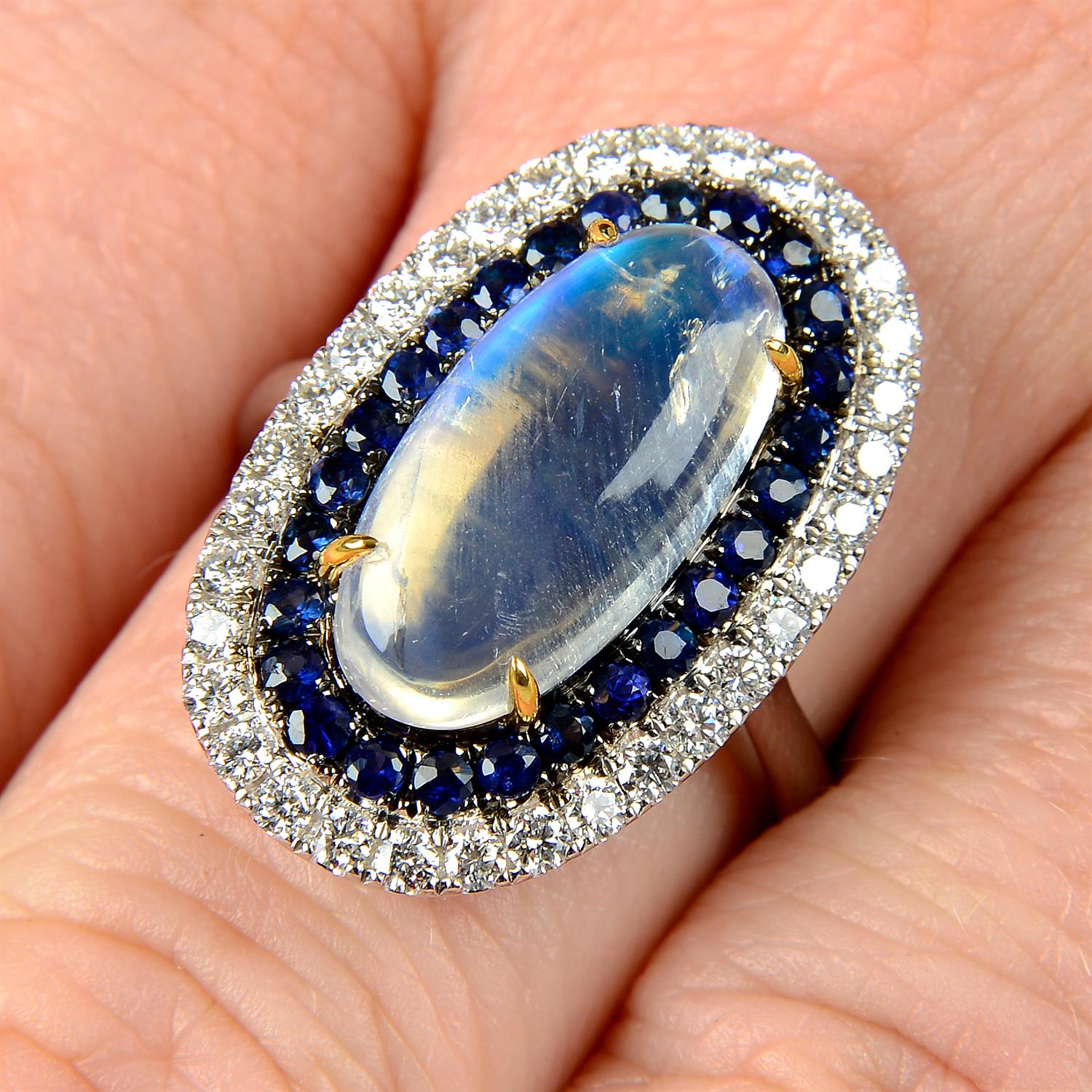 A moonstone, sapphire and diamond ring.