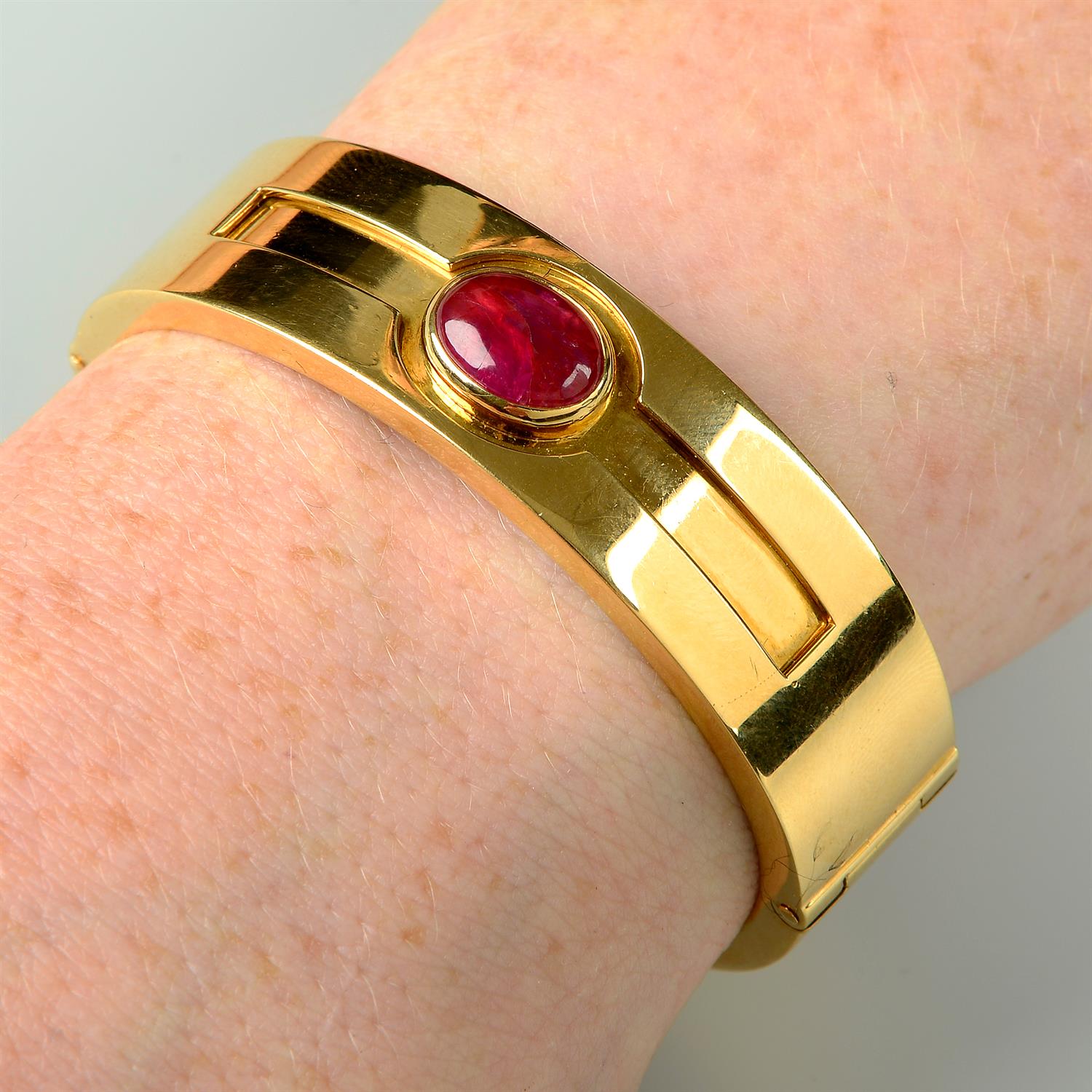 A ruby cabochon hinged bangle cuff, by Bulgari.