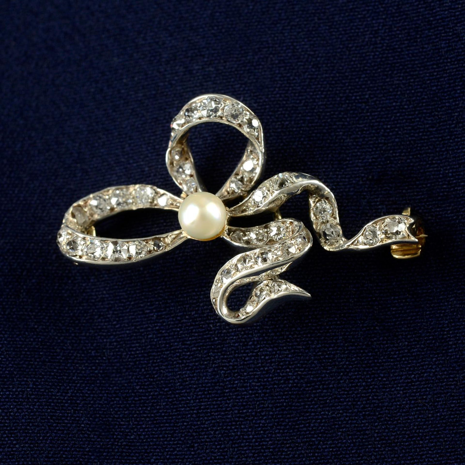 A late 19th century silver and gold, old-cut diamond and pearl ribbon brooch.