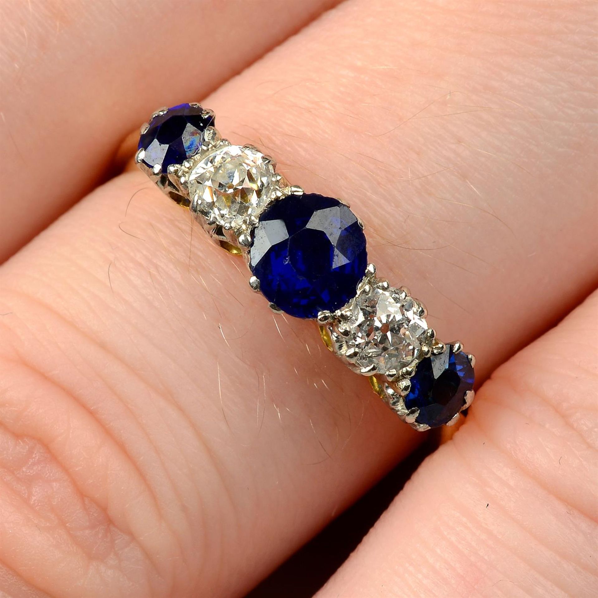 A late Victorian platinum and 18ct gold, graduated sapphire and diamond five-stone ring.