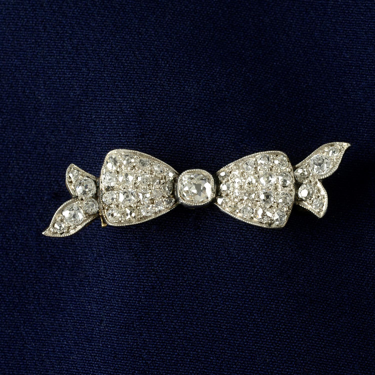 An early 20th century platinum and gold, old-cut diamond bow brooch.