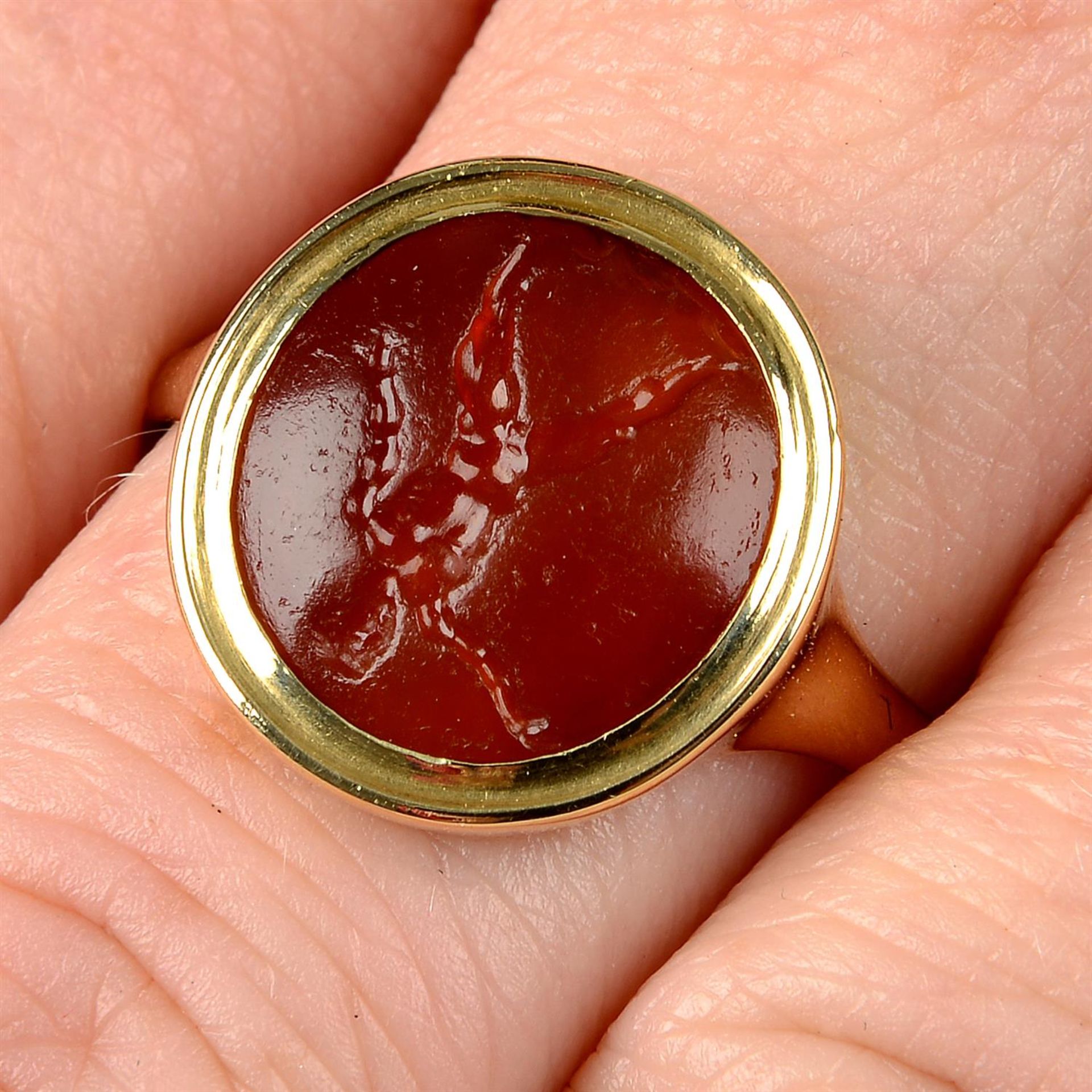 A 19th century gold tassie ring, with intaglio of a man.