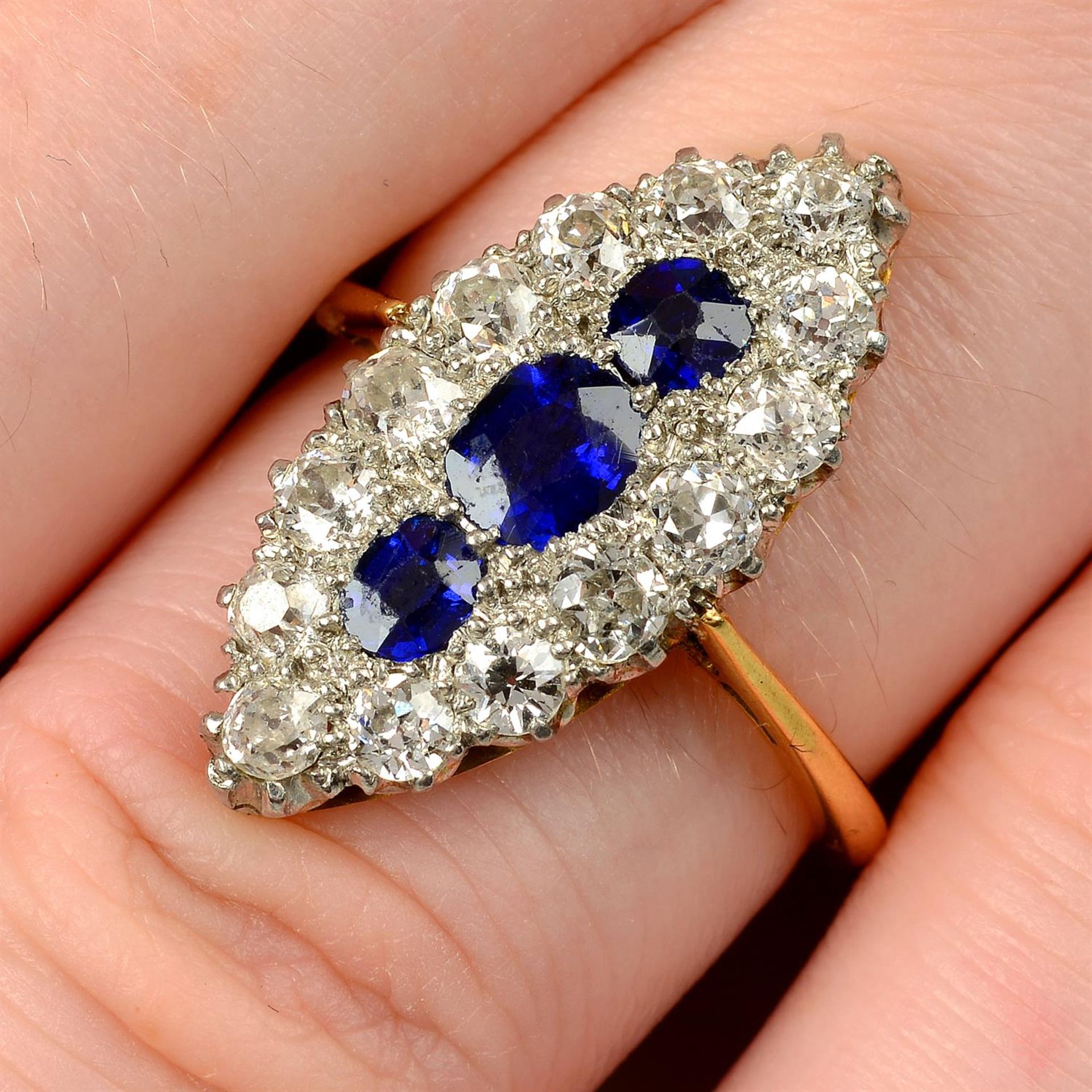 An early 20th century platinum and 18ct gold, sapphire and old-cut diamond navette-shape cluster