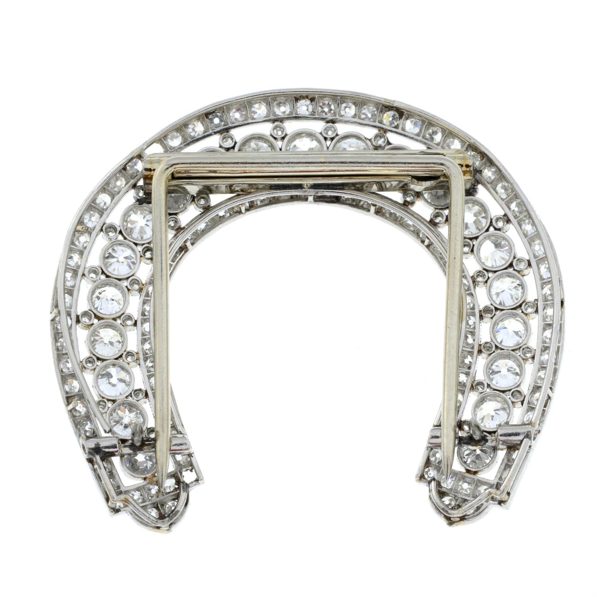 An early 20th century platinum diamond horseshoe-shape clip, by Cartier. - Bild 3 aus 4