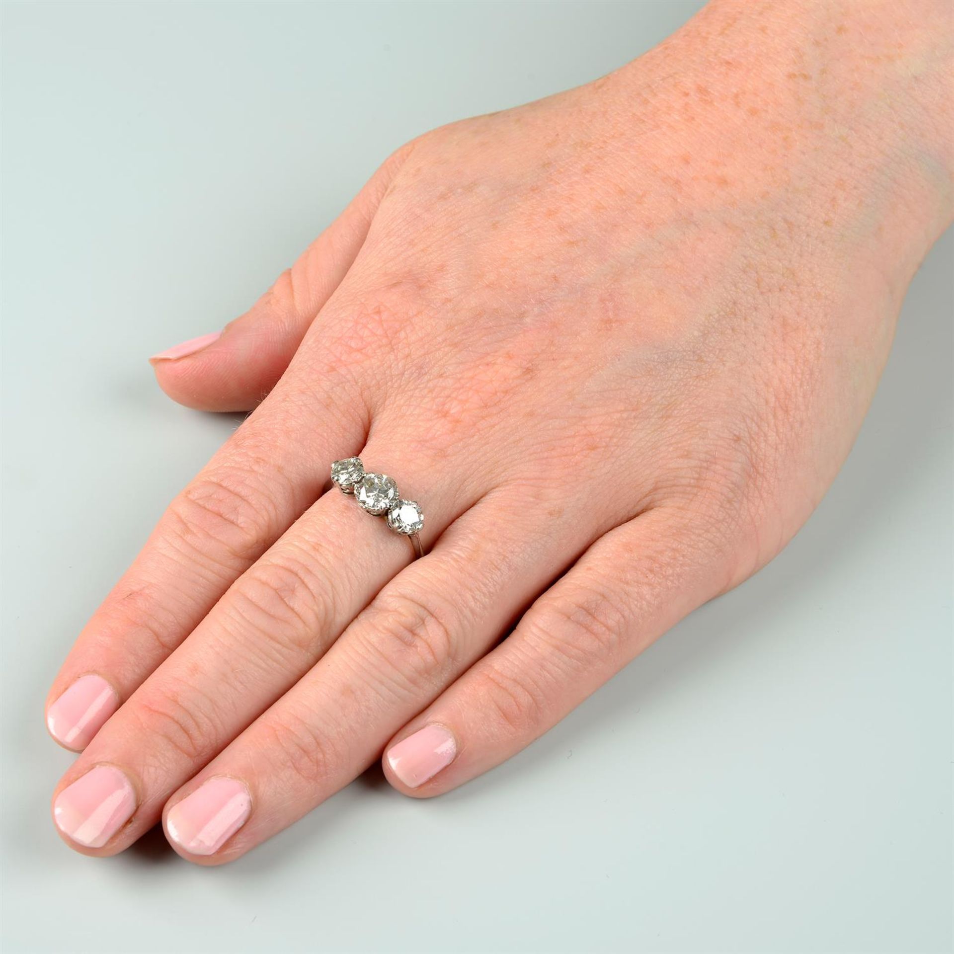 A mid 20th century platinum, graduated diamond three stone ring. - Image 6 of 6