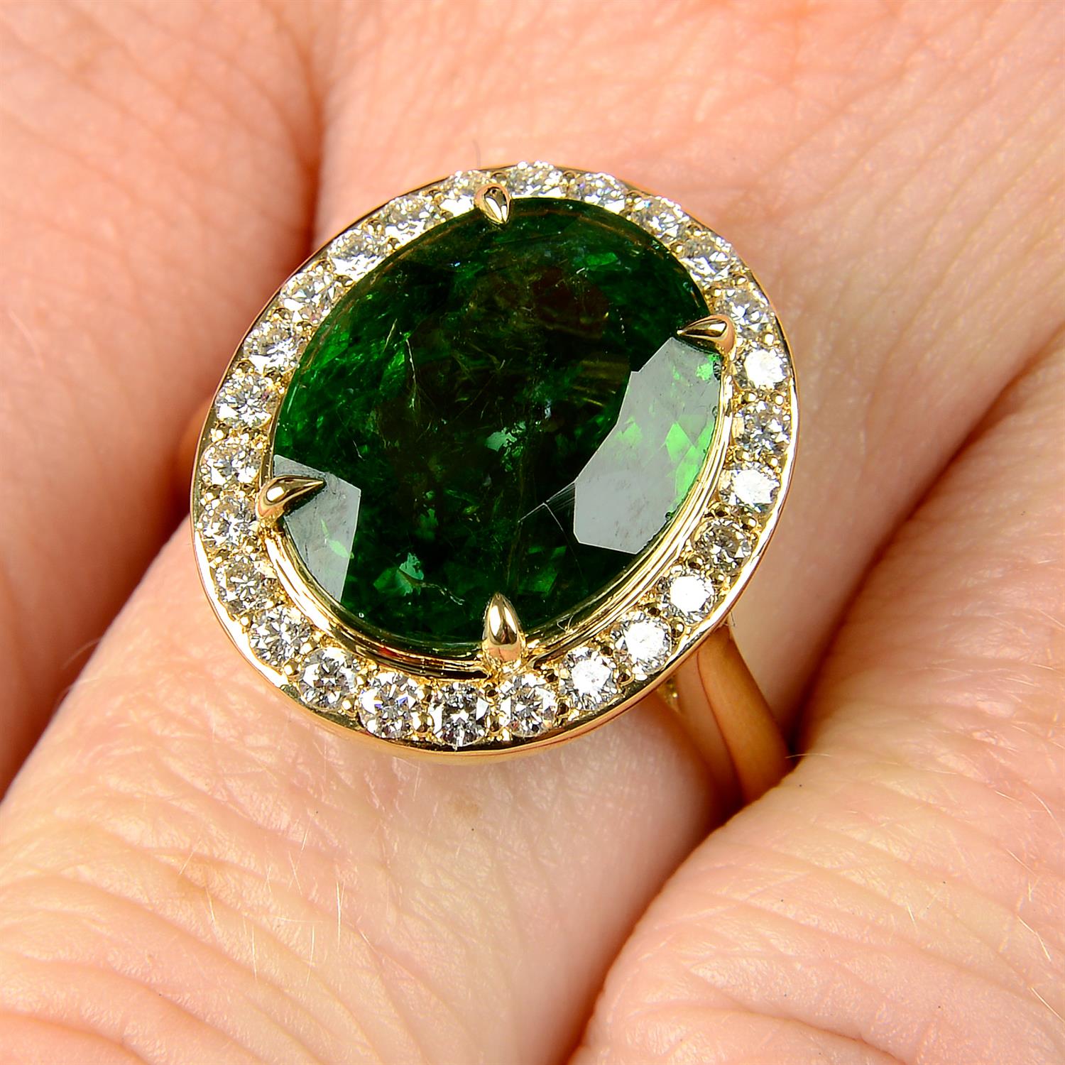 A green tourmaline and brilliant-cut diamond cluster ring.